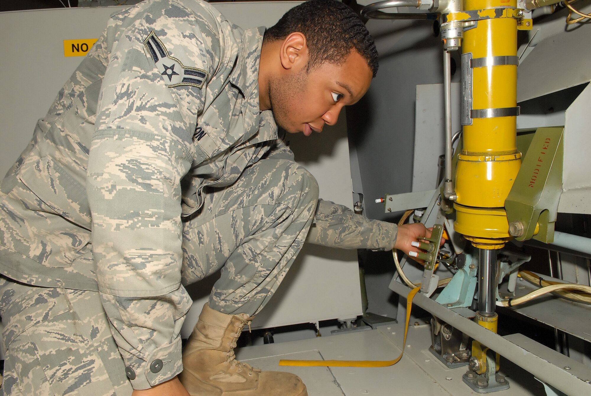 Airman 1st Class Raphael Henson, 436th Maintenance Squadron aerospace maintenance apprentice, inserts pins into the training simulator at Building 206 at Dover Air Force Base, Del. The Maintenance Qualification Training Program teaches Airmen fresh from technical school the specific tasks they will be performing in real-world scenarios. Airman Henson is a maintenance apprentice with the 436th Maintenance Squadron. (U.S. Air Force photos by Airman 1st Class Samuel Taylor)
