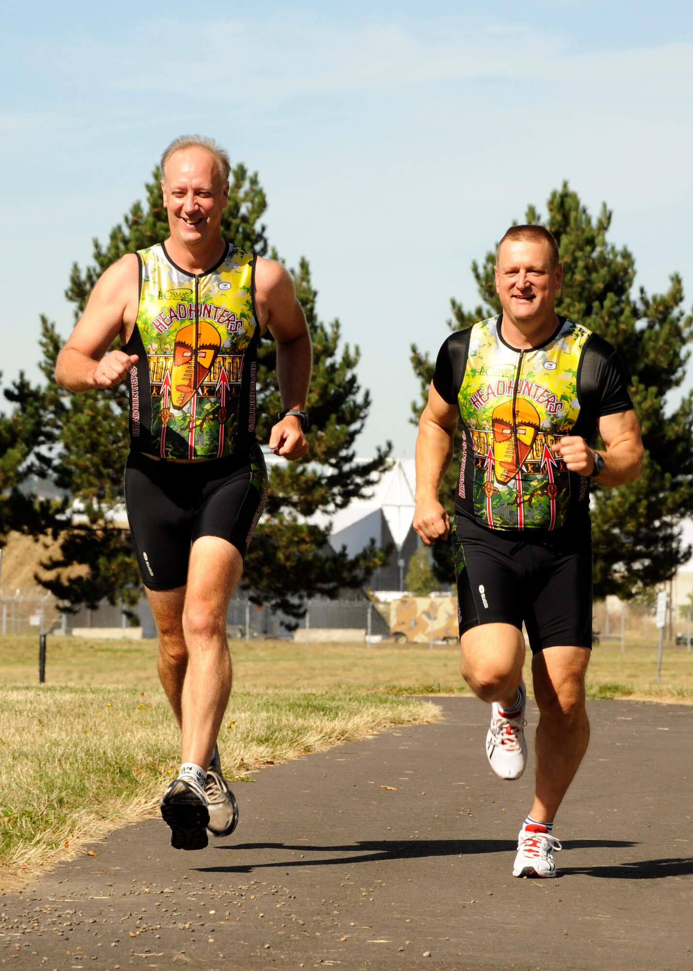 Running along the fitness trail at the Portland Air National Guard Base, U.S. Air Force Master Sgts. Jeff Macey and Brian Cummins stretch out their legs for an afternoon workout.  