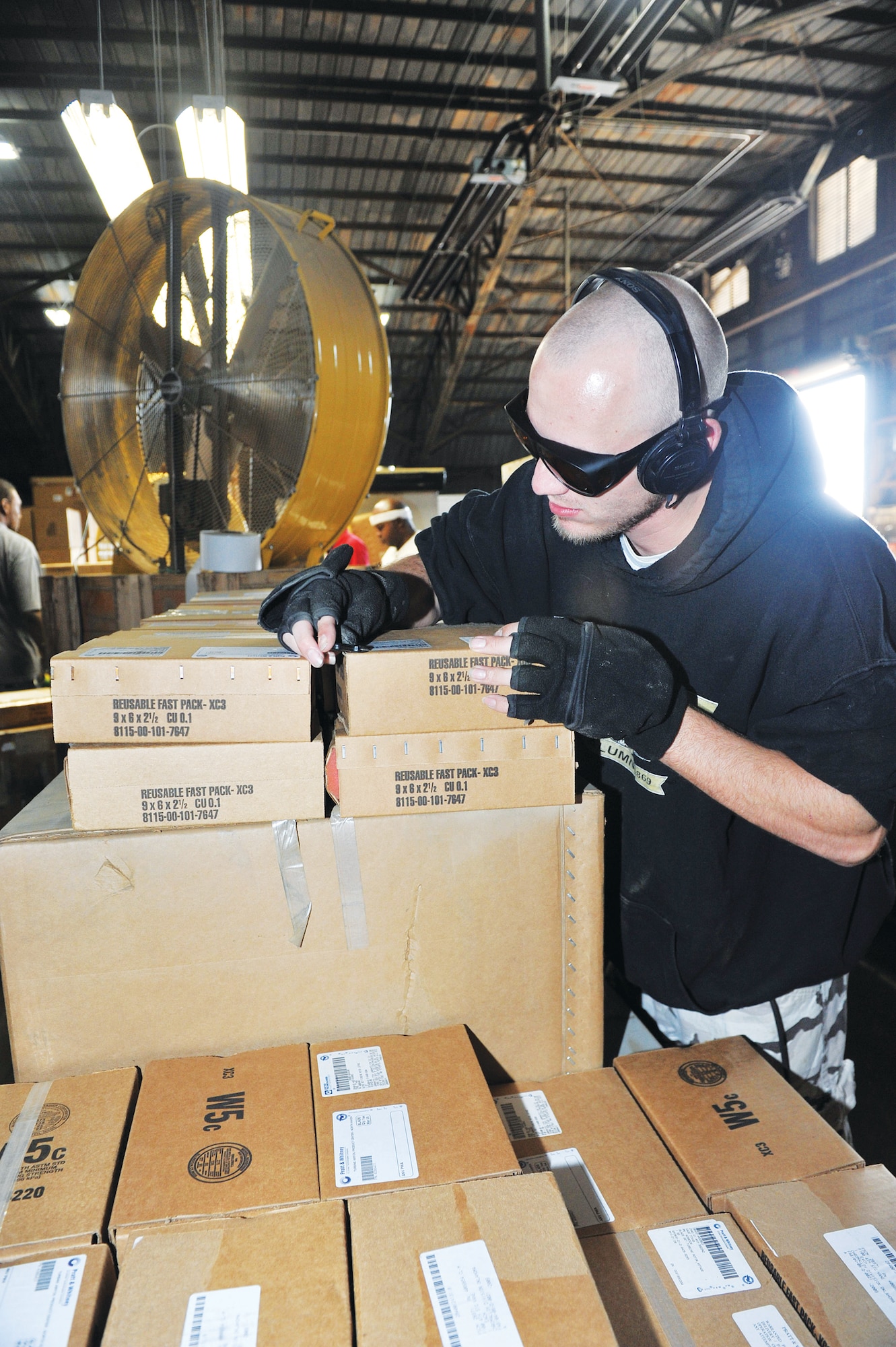 Chad Annis, Georgia Industries for the Blind, inspects boxes which have been repaired. U. S. Air Force photo by Tommie Horton