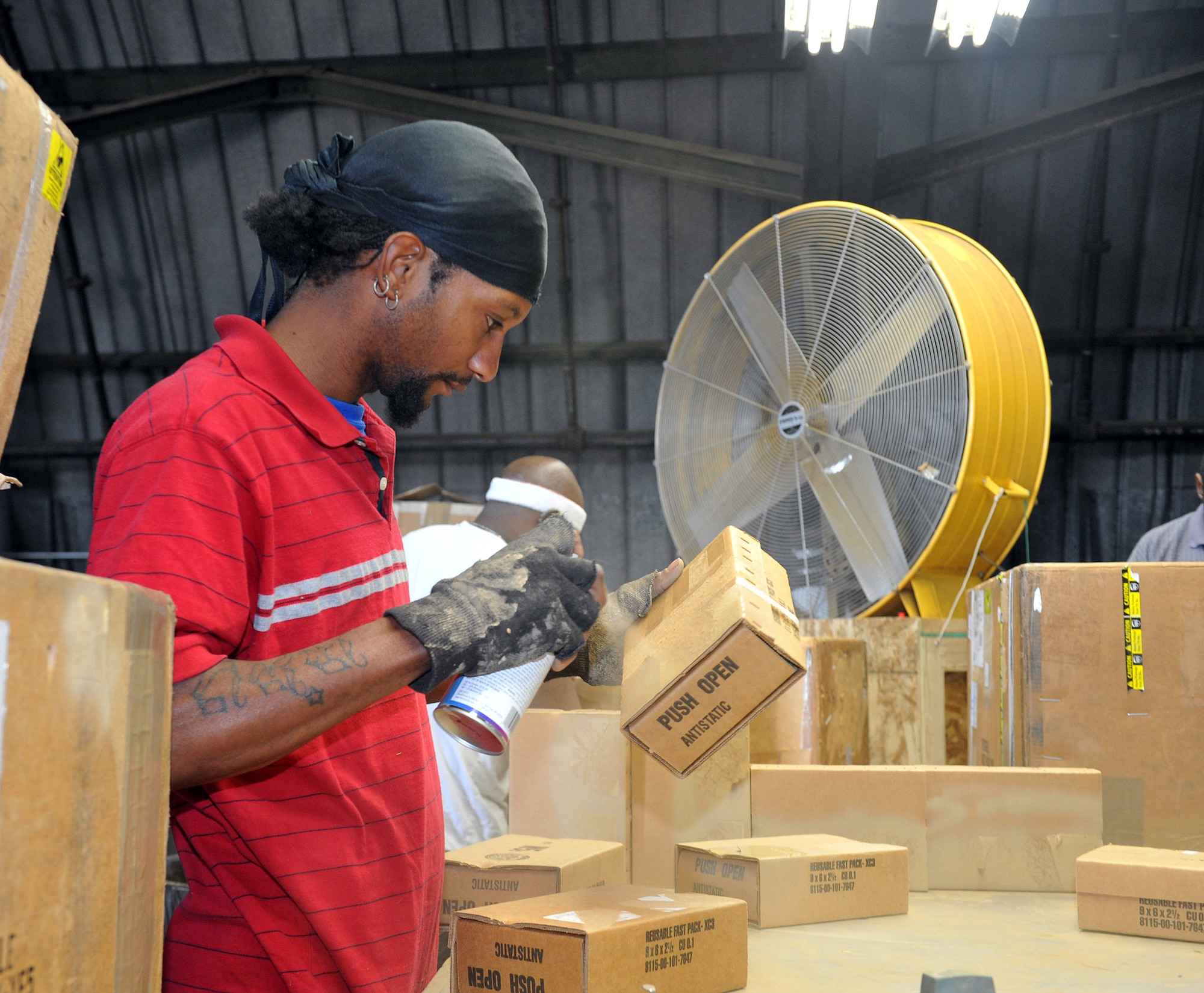 Deon Jones, Georgia Industries for the Blind, prepares boxes for reuse. U. S. Air Force photo by Tommie Horton