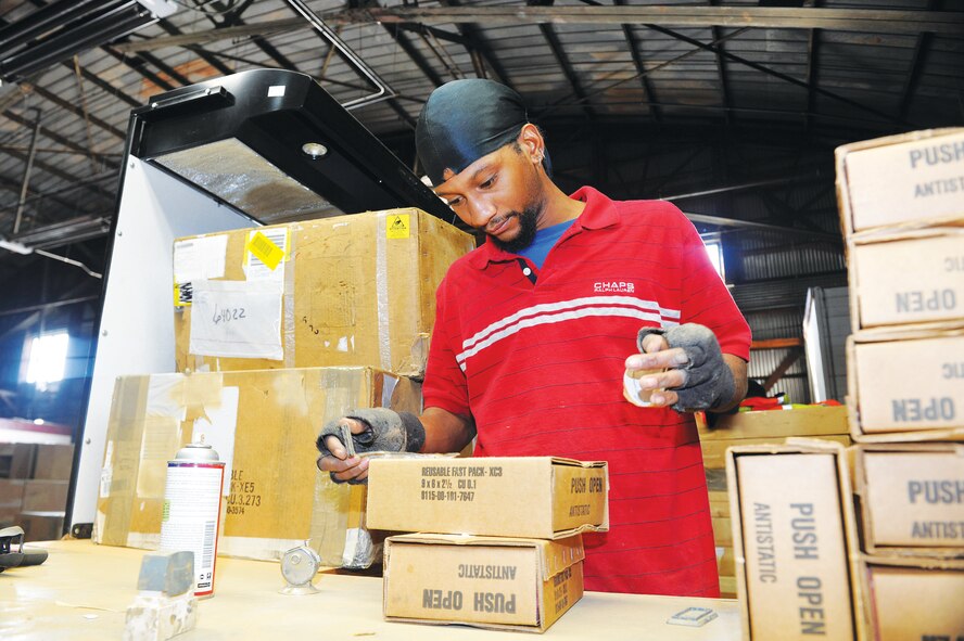 Deon Jones, Georgia Industries for the Blind, prepares boxes for reuse. U. S. Air Force photo by Tommie Horton