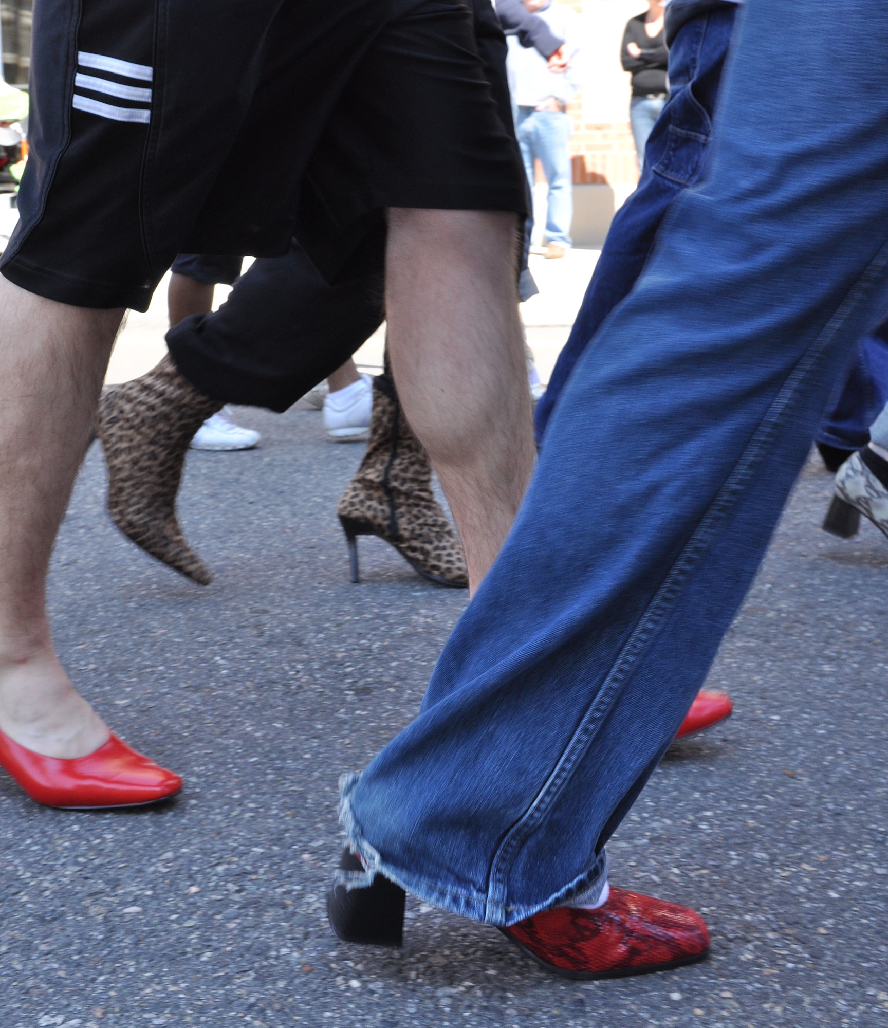 Eleven men assigned to the 633d Communications Squadron spend their Saturday walking a mile in women’s shoes in order to help end sexual violence in Hampton, Va., April 2, 2011. Walk a Mile in Her Shoes is an international Men’s march to stop rape, sexual assault and gender violence. (U.S. Air Force Photo/Tech. Sgt. Christina M. Styer/RELEASED)  