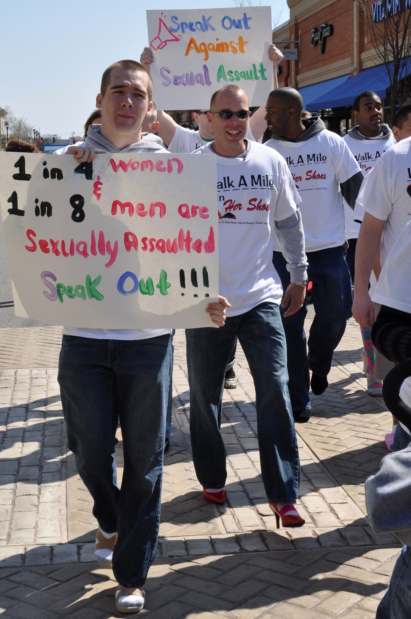 Airmen assigned to the 633d Communications Squadron, raise awareness to sexual violence by walking a mile in women’s shoes during Sexual Assault Awareness month in Hampton, Va., April 2, 2011. The annual march is a “fun way for men to show their support in the fight to end sexual violence” during Sexual Assault Awareness month. (U.S. Air Force Photo/Tech. Sgt. Christina M. Styer/RELEASED)  