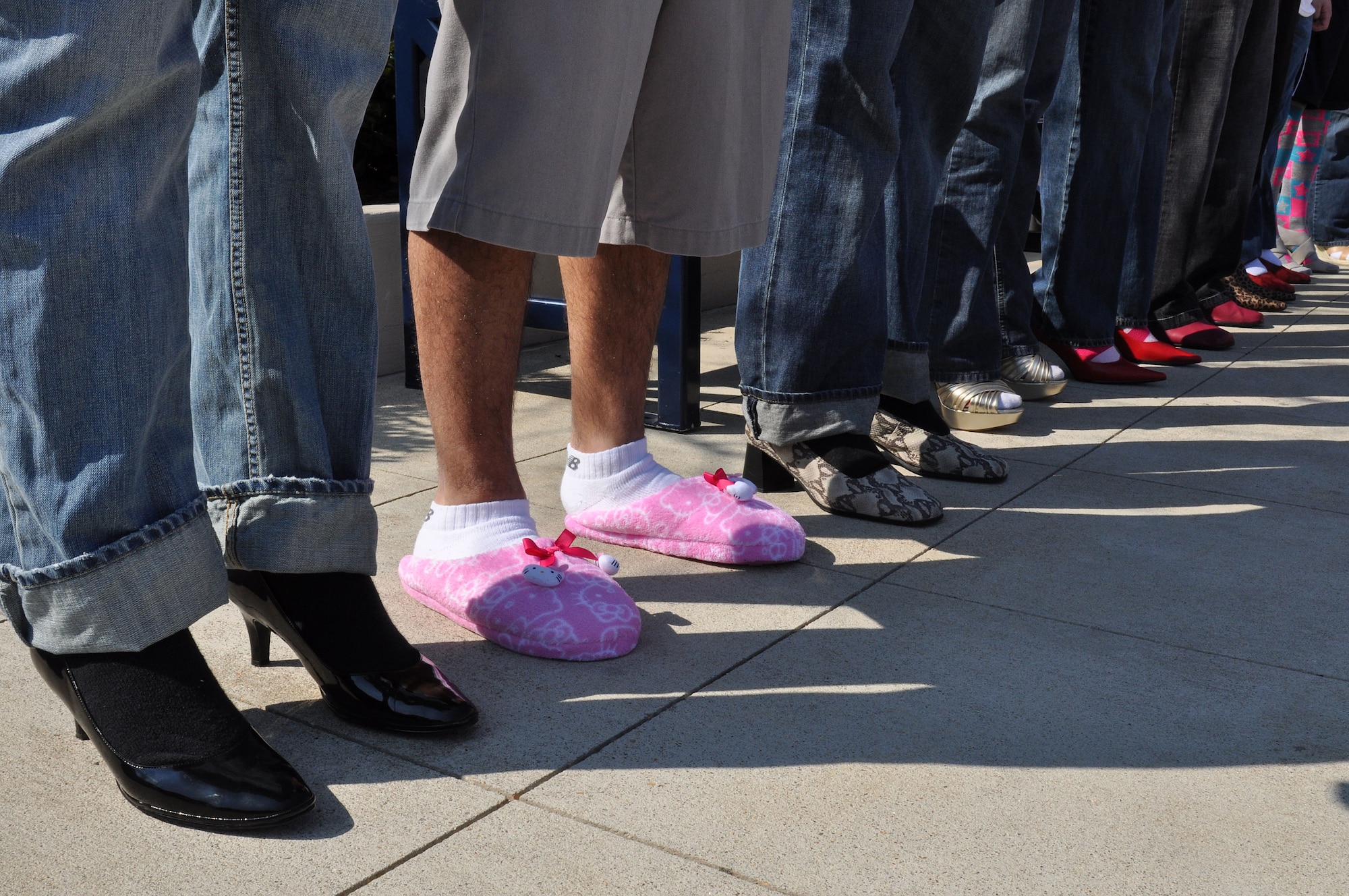 Eleven men assigned to the 633d Communications Squadron spend their Saturday walking a mile in women’s shoes in order to help end sexual violence in Hampton, Va., April 2, 2011. Walk a Mile in Her Shoes is an annual international men’s march held during Sexual Assault Awareness month to help stop rape, sexual assault and gender violence. (U.S. Air Force Photo/Tech. Sgt. Christina M. Styer/RELEASED)  