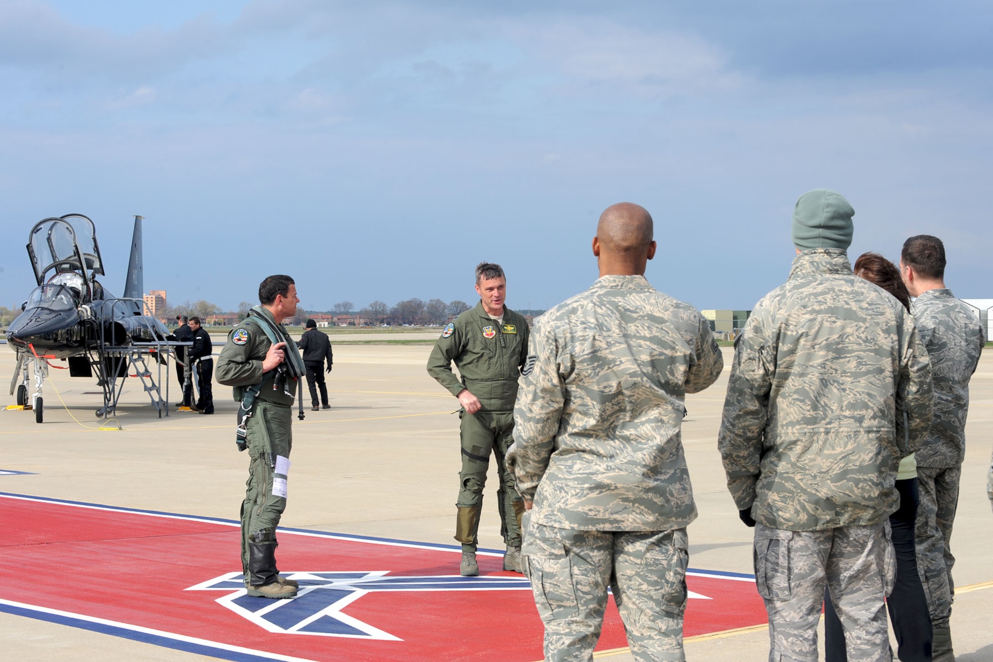 Col. Matthew Molloy, 1st Fighter Wing Commander, and Kevin Mastin, 1st FW vice commander, address members of Team Langley after delivering the T-38 Talon to Langley Air Force Base, Va., April 1, 2011. The T-38, from Holloman AFB, N.M., is TDY here for six months to help train 1st FW pilots and prepare them for when it is permanently stationed here. (U.S. Air Force photo by Staff Sgt. Ashley Hawkins/Released)