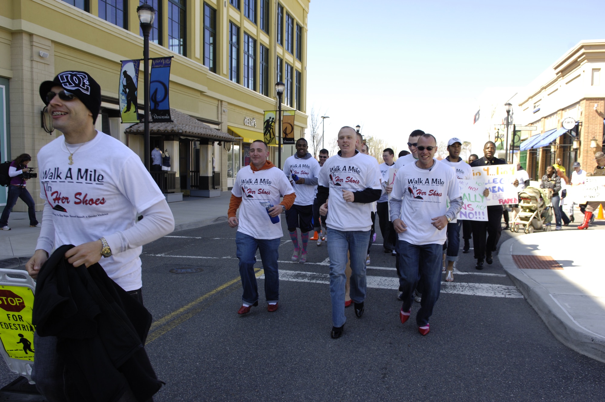 Members of the 633d Communications Squadron double time during the Walk A Mile In Her Shoes event held in Hampton, Va., April 2, 2011. The march is a “fun way for men to show their support in the fight to end sexual violence” and is held worldwide annually during Sexual Assault Awareness month.  (U.S. Air Force photo by Airman 1st Class Camilla Elizeu/Released)