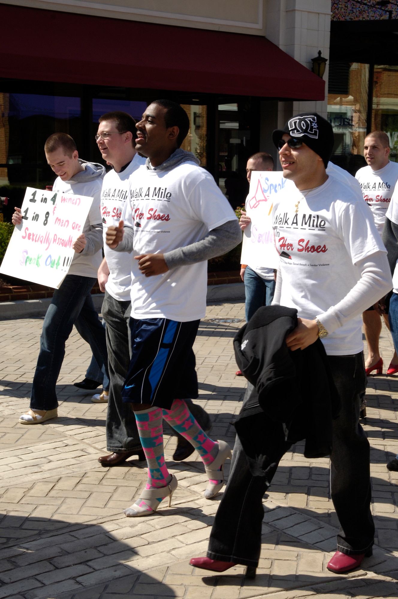 Members of the 633d Communications Squadron participate in the Walk A Mile In Her Shoes event in Hampton, Va., April 2, 2011. The march is a “fun way for men to show their support in the fight to end sexual violence” and is held worldwide annually during Sexual Assault Awareness month.  (U.S. Air Force photo by Airman 1st Class Camilla Elizeu/Released)