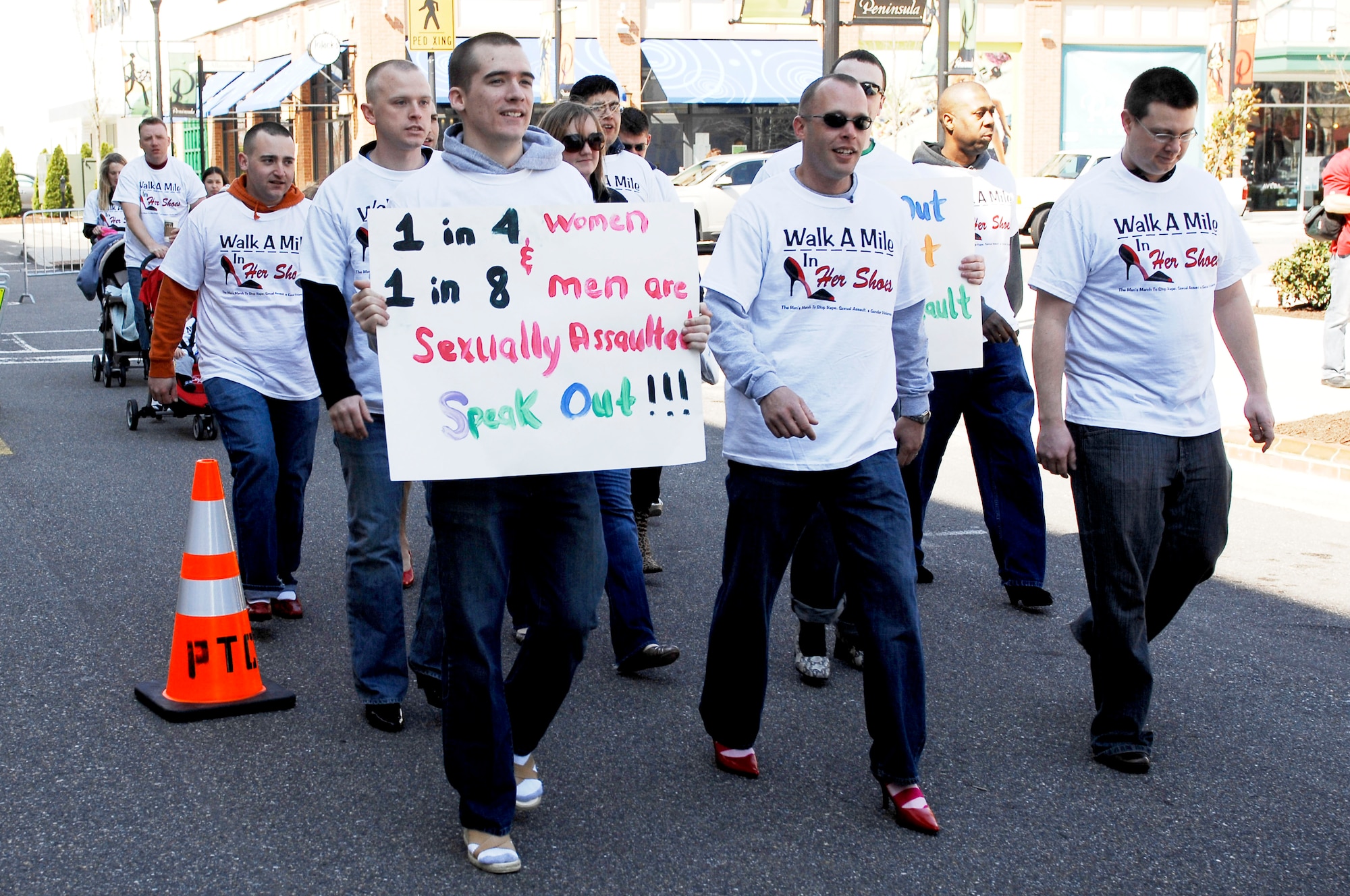 Eleven men assigned to the 633d Communications Squadron participate in Walk a Mile in Her Shoes to show their support for the fight to end sexual violence in Hampton, Va., April 2, 2011. The march is a “fun way for men to show their support in the fight to end sexual violence.” (U.S Air Force photo by Airman 1st Class Kayla Newman/Released)