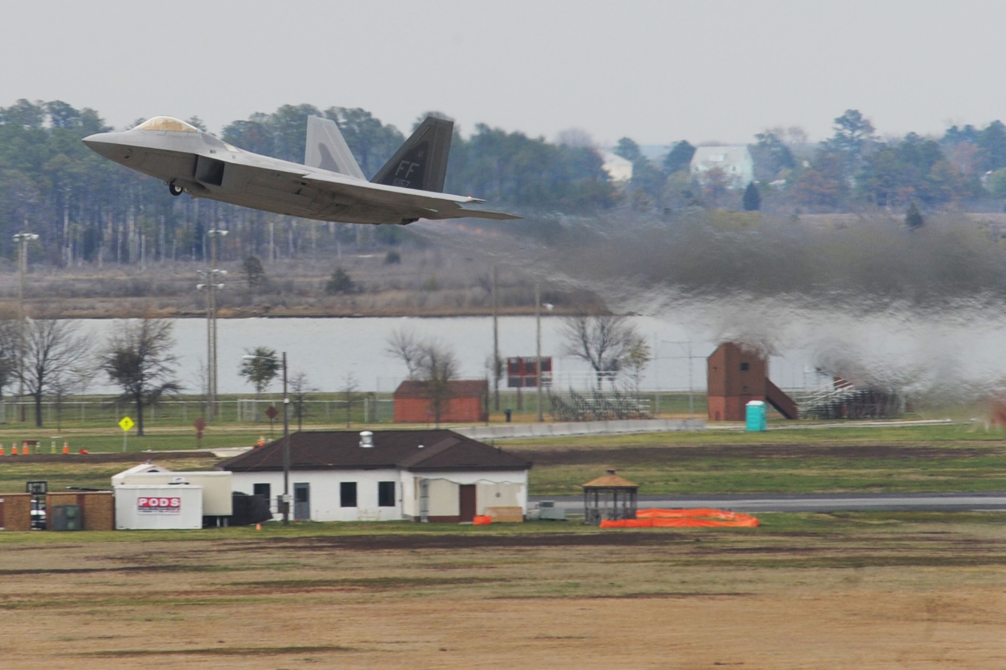 An F-22 Raptor takes off from Langley Air Force Base, Va., to escort a T-38 Talon, from Holloman AFB, N.M., April 1, 2011. The T-38 is on temporary assignment to support combat readiness training for the 1st FW pilots. (U.S. Air Force photo by Senior Airman Brian Ybarbo/Released)
   