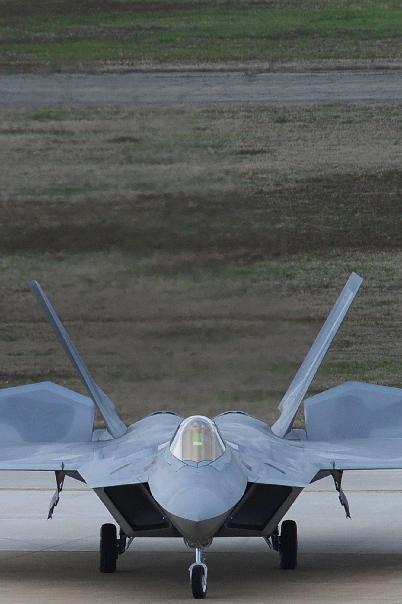 An F-22 Raptor arrives on the Langley Air Force Base, Va., flightline after escorting a T-38 Talon from Holloman AFB, N.M., April 1, 2011. The T-38 is temporarily assigned to the 1st Fighter Wing to support combat readiness training for the pilots. (U.S. Air Force photo by Senior Airman Brian Ybarbo/Released)

   