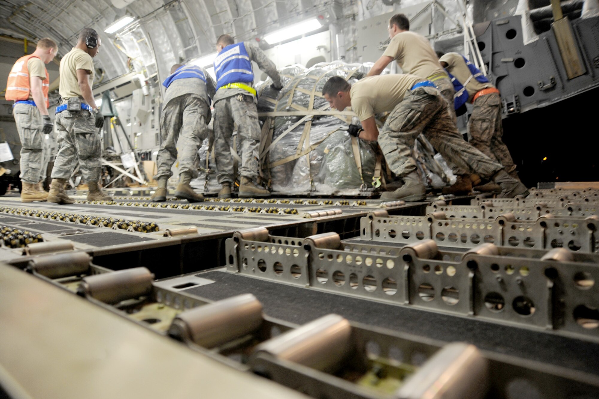 Airmen assignd to the the 22nd Logistics Readiness Squadron load equipment onto a C-17 Globemaster III March 20, 2011, at McConnell Air Force Base, Kan., in support of Operation Odyssey Dawn. (U.S. Air Force photo/Staff Sgt. Dallas Edwards)