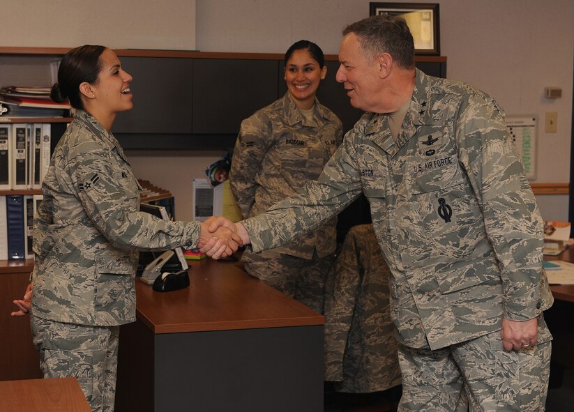 Maj. Gen. C. Donald Alston, 20th Air Force commander, stopped to visit with Airmen in the customer support section of the military personnel flight while visiting Malmstrom March 30. Here he shakes hands with Airman 1st Class Chere Ward while Airman 1st Class Sulai Baddour looks on. (U.S. Air Force photo/Beau Wade)