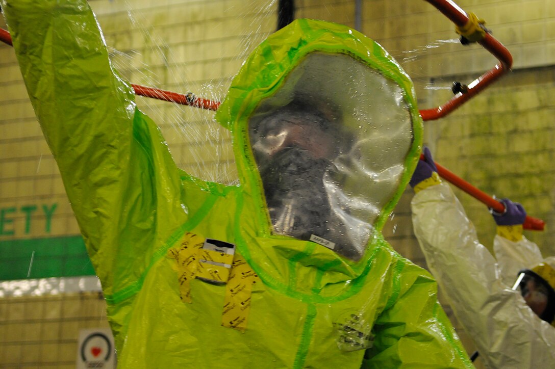 Major Michael Fea, 779 Aerospace medicine squadron flight commander, gets decontaminated by Airman 1st Class Bridgette Brzezinsky, 779 Aerospace medicine squadron bioenvironmental apprentice, after leaving a suspected radioactively contaminated area during a Black Flag exercise at the Center for Center for National Response in Gallagher West Virginia, March 29. Members from the 79 Medical Wing, 11 Civil Engineer Squadron and Air Force District of Washington participate in a 5 days of exercises each year to sharpen their chemical, , radiological, nuclear or high-yield explosive readiness skills. (U.S. Air Force photo by Senior Airman Melissa V. Brownstein)