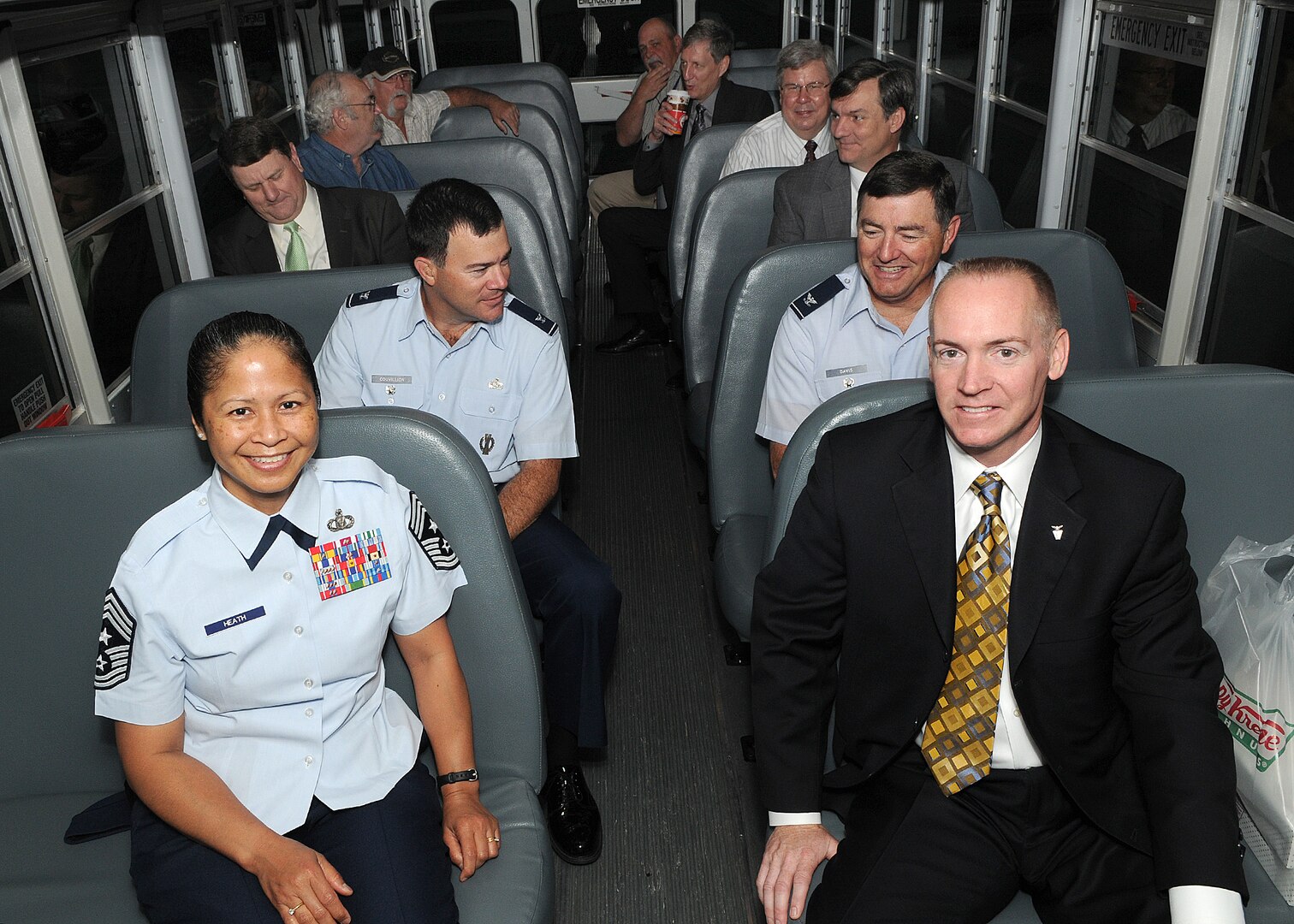 Randolph AFB, TX, 4/4/2011:  Dr. Todd Fore and Chief Master Sgt. Arleen Heath  get front seats on the inaugural run of the new Headquarters Air Force Personnel Center shuttle bus  early April 4, 2011 on Randolph Air Force Base, Texas. During renovation of HQ AFPC the bus service will shuttle  personnel from the parking lot between the Kendrick Enlisted Club and the P-Xtra  to their temporary offices in  building 977 daily from 6-8 a.m., 11-1  p.m. and 3-5 p.m.  The bus will also pick up passengers at HQ AFPC and the parking lot south of hangar 16. Dr. Fore is the HQ AFPC Executive Director, and CMSgt. Heath is the AFPC Command Chief. Seated directly behind them are Col. Jerry Couvillion, left,  AFPC Deputy Director of Assignments  and Col. Jim Davis, Director of Total Force Service Center. The shuttle bus service is being offered because of limited parking at building 977 which is located behind Chapel 2. (U.S. Air Force photo/David Terry)