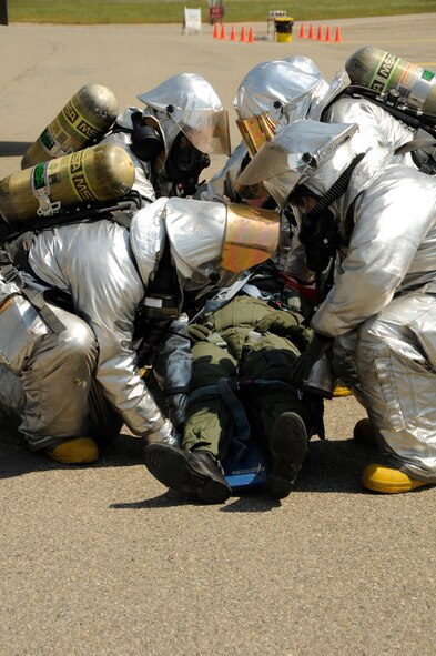 U.S. Air Force firefighters assigned to the 144th Civil Engineer Squadron, 144th Fighter Wing, California Air National Guard strap an incapacitated pilot to a litter after they extracted him from a F-16 fighter aircraft during an Operational Readiness Inspection in Fresno, Calif., April 1, 2011.  The inspection evaluates a unit’s ability to perform its wartime mission.  (U.S. Air Force photo by Master Sgt. David J. Loeffler / released)