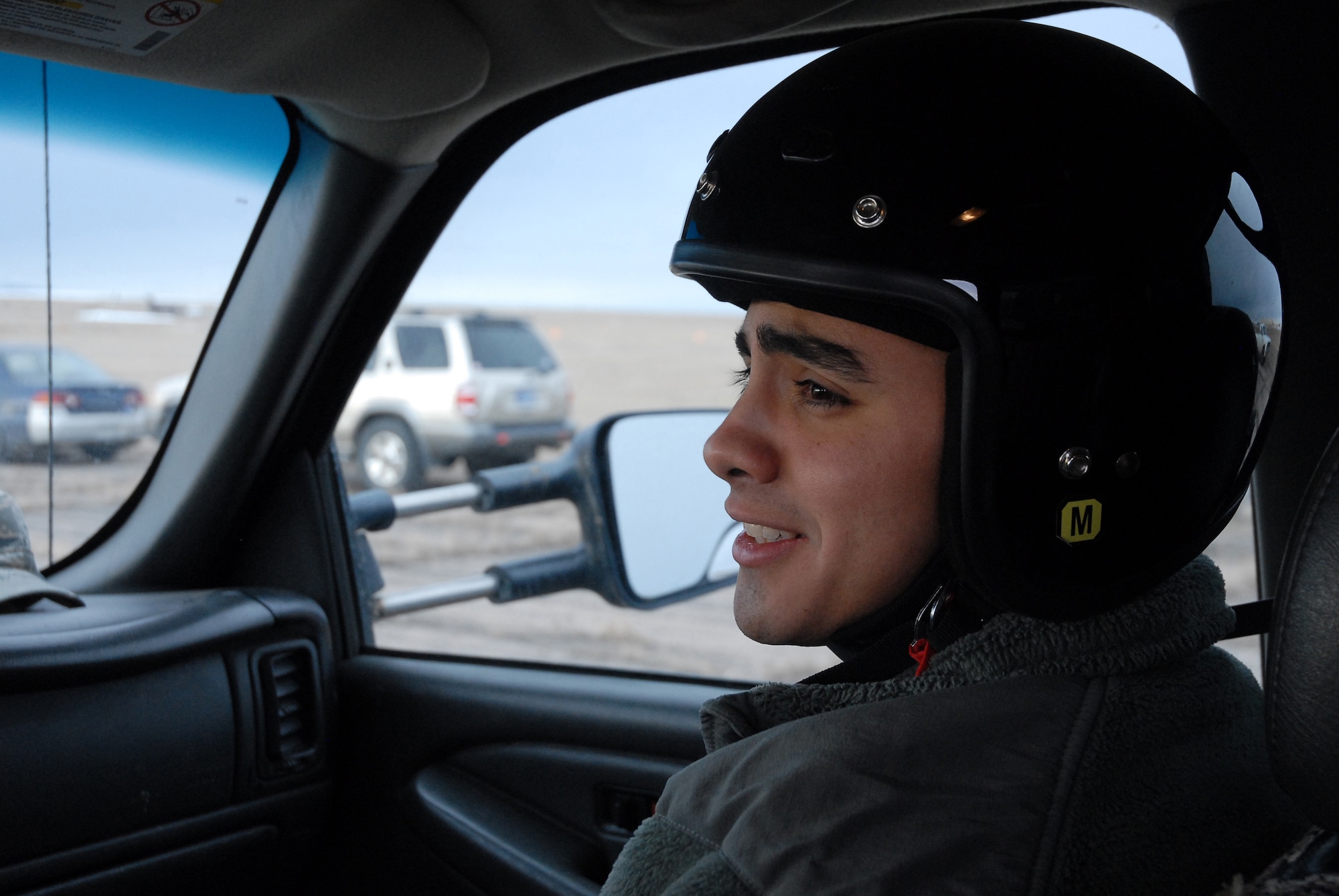 Airman 1st Class Daniel Garcia,341st Maintenance Group Facility Maintenance Section team member listens to instructions given by Staff Sgt. James Broderick, 341st MXG driving instructor near on the gravel road course March 15. (U.S. Air Force photo/Staff Sgt. Dillon White)