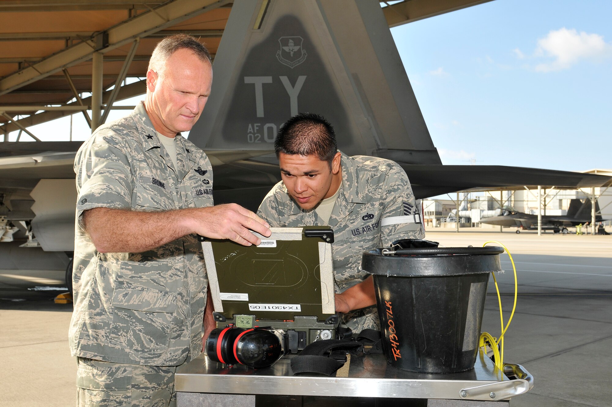 Brigadier Gen. James Browne, 325th Fighter Wing commander, learns about the mission of Staff Sgt. Joel Dulatre, 325th Aircraft Mainetnance Squadron F-22 Raptor dedicated crew chief, as part of the Airman Shadow Porogram April 1. (U.S. Air Force phot by Lisa Norman)