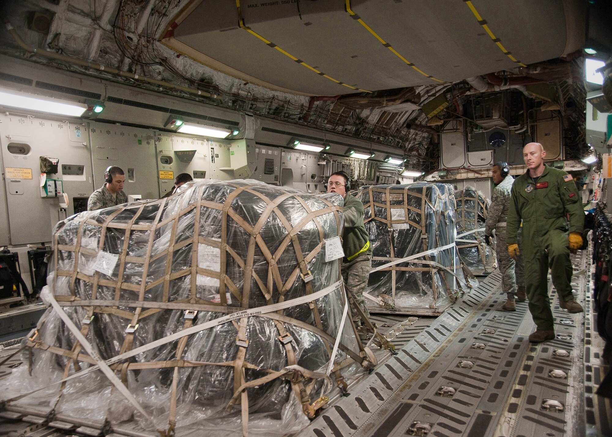Airmen from the 730th Air Mobility Squadron unload water pumps and hoses off a C-17 Globemaster III March 30, 2011, at Yokota Air Base, Japan. The aircraft delivered 20,000 pounds of cooling equipment for the Fukushima nuclear plant. (U.S. Air Force photo/Airman 1st Class Andrea Salazar) 