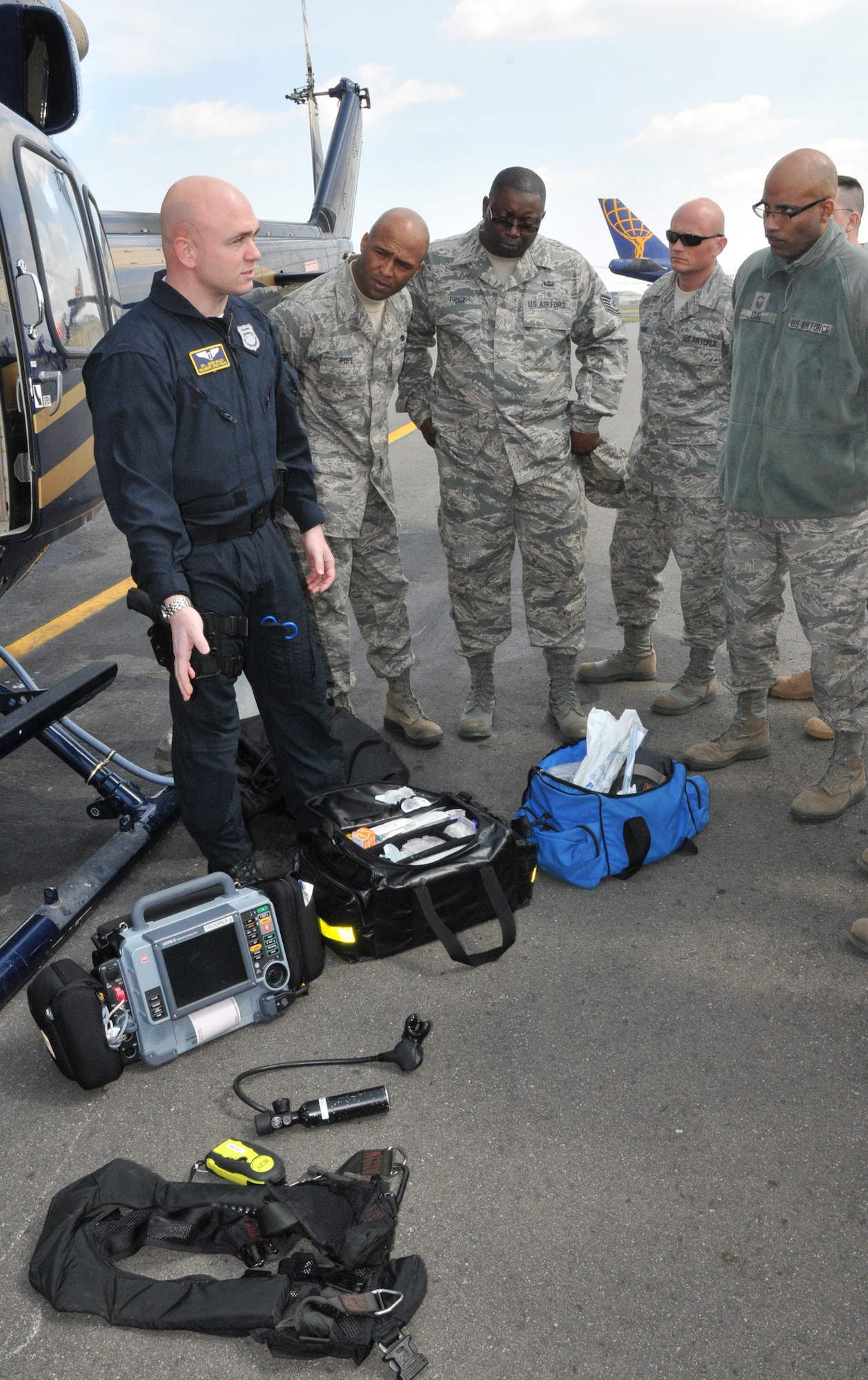 Cpl. Jason Baxley, a medic with the Delaware State Police Aviation Section, briefs Air Force Reserve medics assigned to the 512th Aerospace Medicine Squadron here about the equipment he uses when evacuating patients from an accident scene. The 512th AMDS paired up with the DSP to get helicopter familiarization training and learn how DSP emergency responders conduct their mission. (U.S. Air Force photo by Capt. Marnee A.C. Losurdo)