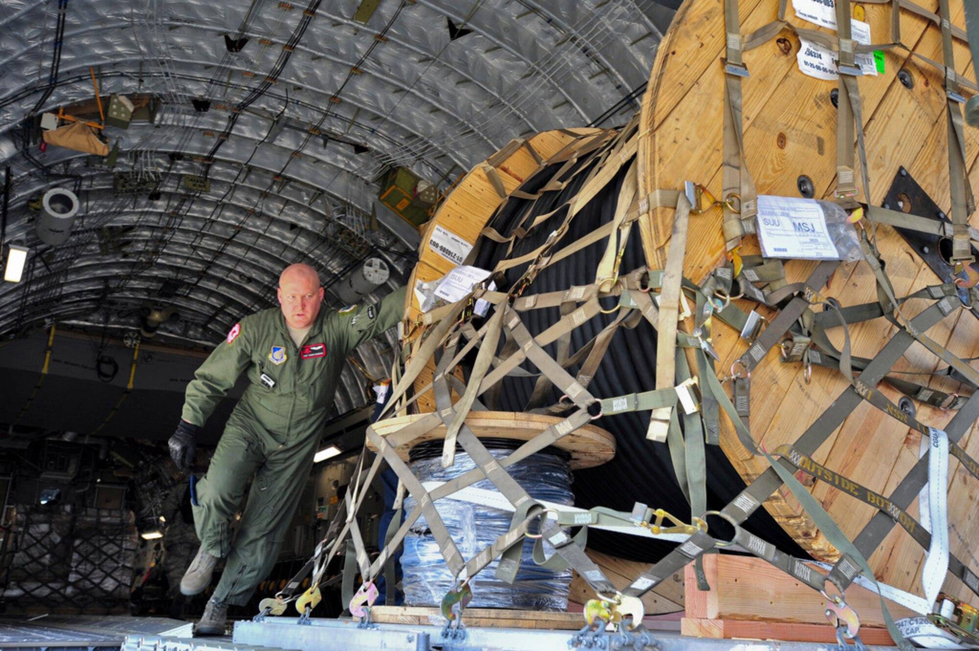 MISAWA AIR BASE, Japan -- Technical Sgt. Travis Duxsbury, a loadmaster with the 517th Airlift Squadron, offloads cargo from a C-17 Globemaster III here, April 1. Duxsbury and fellow members of the 517th from Joint Base Elmendorf-Richardson, Alaska are providing support to Operation Tomodachi by shuttling supplies to and from bases around Japan. (U.S. Air Force Photo/ Staff Sgt. Joshua Garcia)