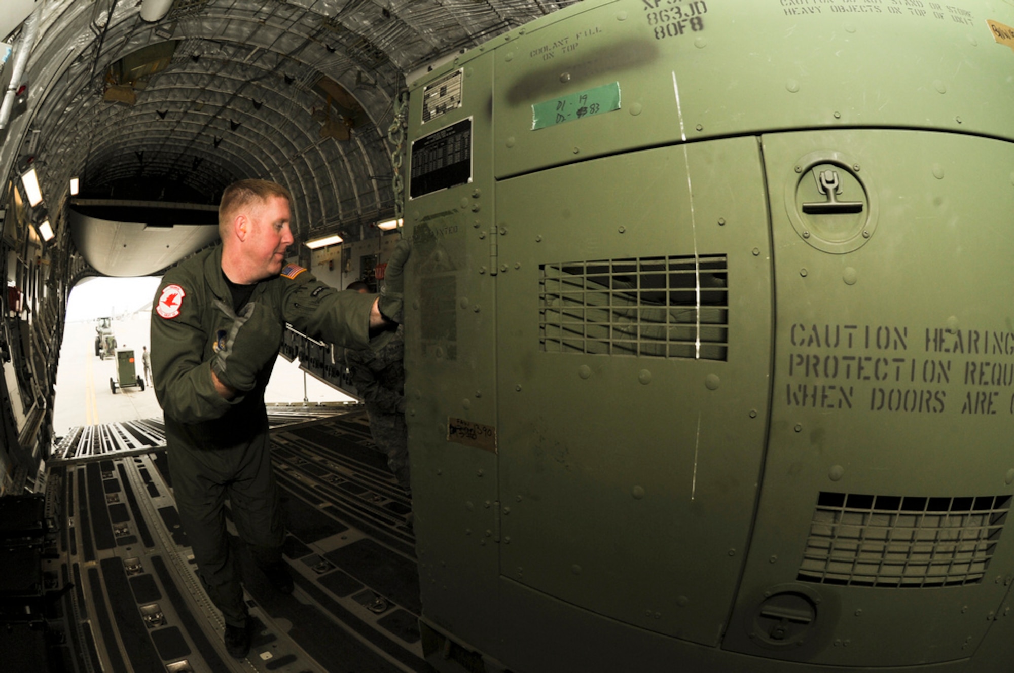 MISAWA AIR BASE, Japan -- Technical Sgt. Ryan Eads, a loadmaster with the 517th Airlift Squadron, loads a generator onto a C-17 Globemaster III here, April 1. The generators were en-route Yokota Air Base, Japan to provide support for Operation Tomodachi. (U.S. Air Force Photo/ Staff Sgt. Joshua Garcia)