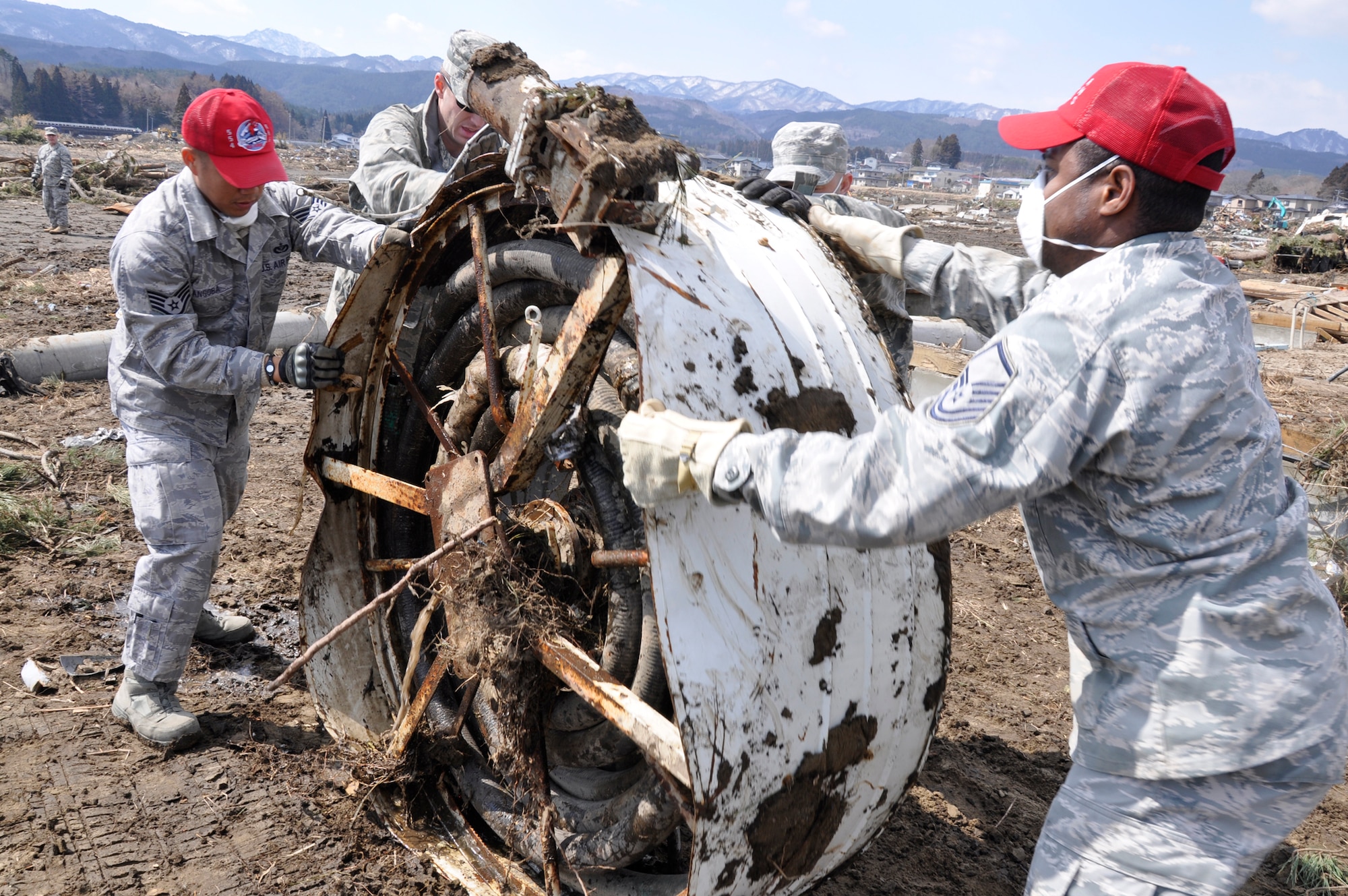 Airmen rotate a water treatment system across a tsunami-struck area March 29, 2011, in Noda Mura, Japan. (U.S. Air Force photo/Senior Airman Joe McFadden)