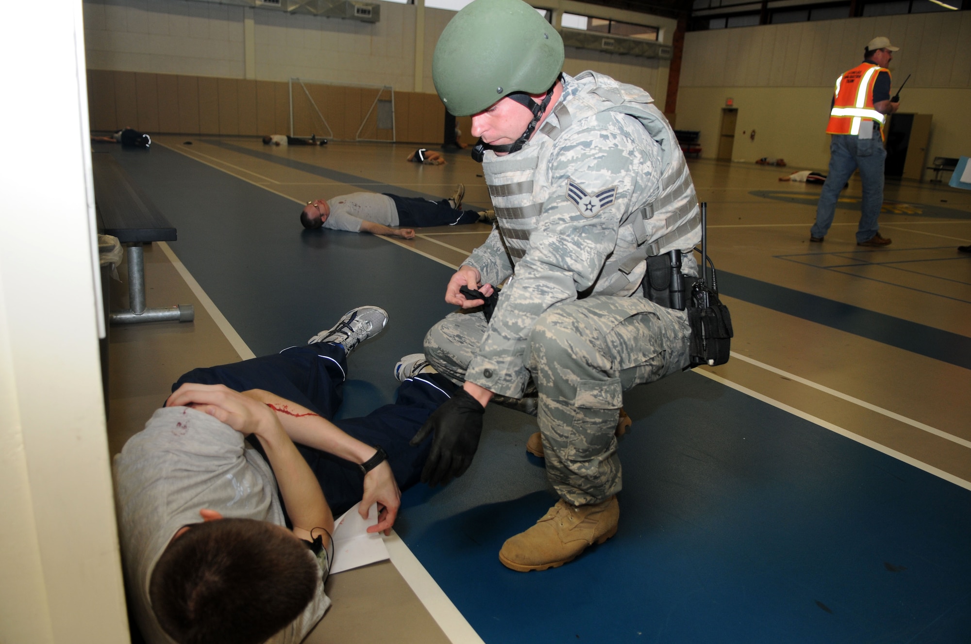GOODFELLOW AIR FORCE BASE, Texas— Senior Airman Steven McCoy, 17th Security Forces Squadron,  reacts quickly to access the situation during the aftermath of a simulated active shooter at Carswell Field House, here March 26.  The base-wide exercise tested the capabilities of base personnel as well as the San Angelo hospitals and San Angelo Fire Department. (U.S. Air Force photo/Staff Sgt. Heather Rodgers)