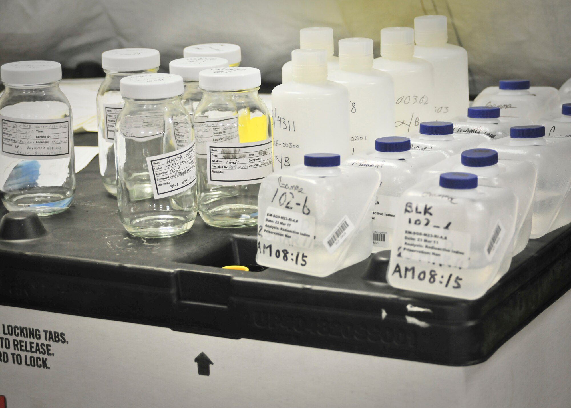YOKOTA AIR BASE, Japan -- Containers filled with water from numerous local areas await to be examined inside the Air Force Radiation Assessment Team laboratory here March 25. The AFRAT consistently monitored elements from the surrounding areas of Yokota and Camp Zama for possible presence of radiation. (U.S. Air Force photo/Airman 1st Class Andrea Salazar)