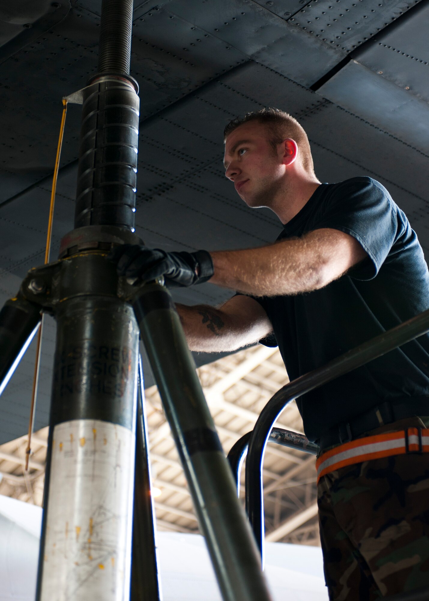 YOKOTA AIR BASE, Japan -- An Airmen from the 374th Aircraft Maintenance Squadron monitors the left wing of a C-130 Hercules while being lifted here April 2. The aircraft was lifted so the landing gear could be inspected. (U.S. Air Force photo/Staff Sgt. Chad C. Strohmeyer)