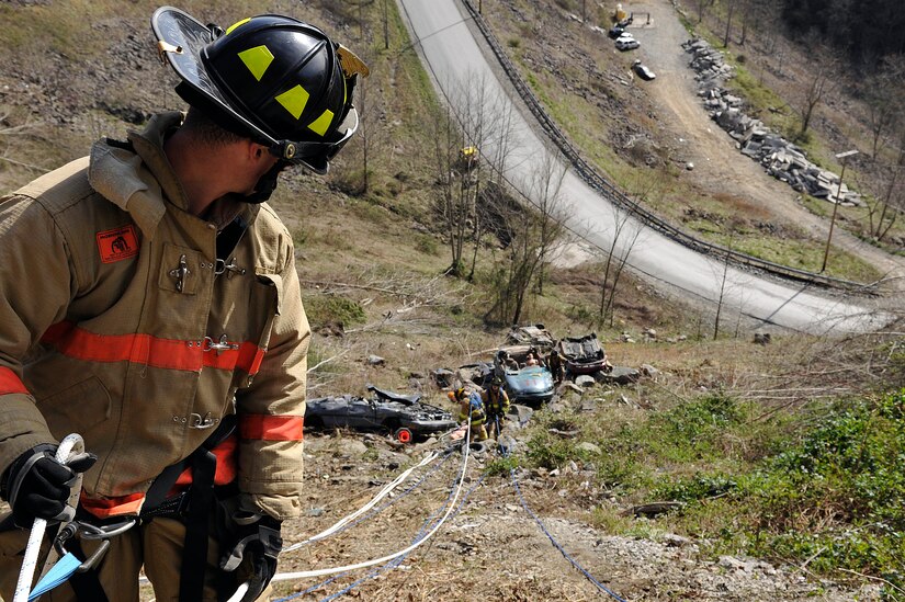 Airman Daniel Bowers, 11th Civil Engineer Squadron firefighter, acts as a belayman safety for a repelling team during a high angle auto extrication at the Center for National Response (CNR)  training facility in Gallagher, W. Va., March 29. The CNR offers specialized training facilities to give first responders a chance to practice skills not often used.  (U.S. Air Force photo/ Senior Airman Melissa V. Brownstein)