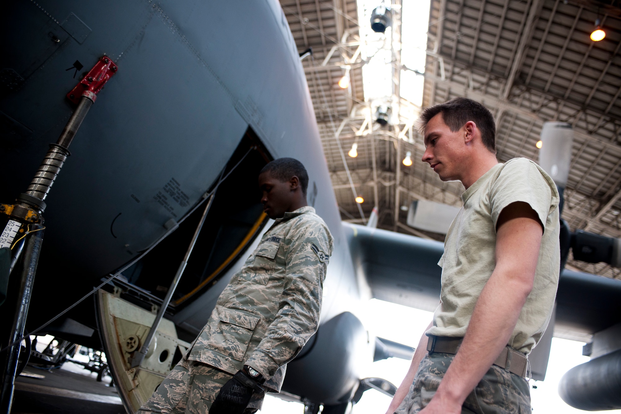 YOKOTA AIR BASE, Japan -- Airmen from the 374th Aircraft Maintenance Squadron prepare a C-130 Hercules to be lifted for maintenance here April 2. The aircraft was lifted so the landing gear could be inspected. (U.S. Air Force photo/Staff Sgt. Chad C. Strohmeyer)