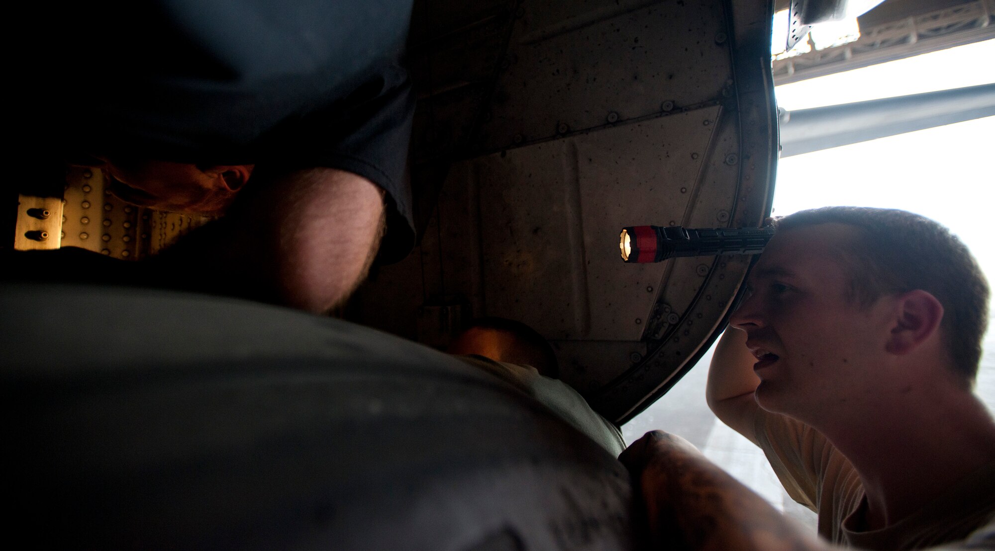 YOKOTA AIR BASE, Japan -- Senior Airman Bruce Quillen, 374th Aircraft Maintenance Squadron crew chief, checks the landing gear on a C-130 Hercules here April 2. In support of Operation Tomodachi, maintainers have worked extended hours to make sure all aircraft are ready for the relief effort. (U.S. Air Force photo/Staff Sgt. Chad C. Strohmeyer)