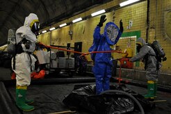Members of the 79th Medical Wing and the 11th Civil Engineer Squadron decontaminate a member of their team during a Black Flag exercise in Gallagher, W. Va, March 29. Personnel from the Air Force District of Washington participated in five days of exercises at the Center for National Response which provides state of the art training on weapons of mass destruction, counterterrorism and consequence management along with operational on site equipment to help familiarize personnel with these subjects.  (U.S. Air Force photo/ Senior Airman Melissa V. Brownstein)