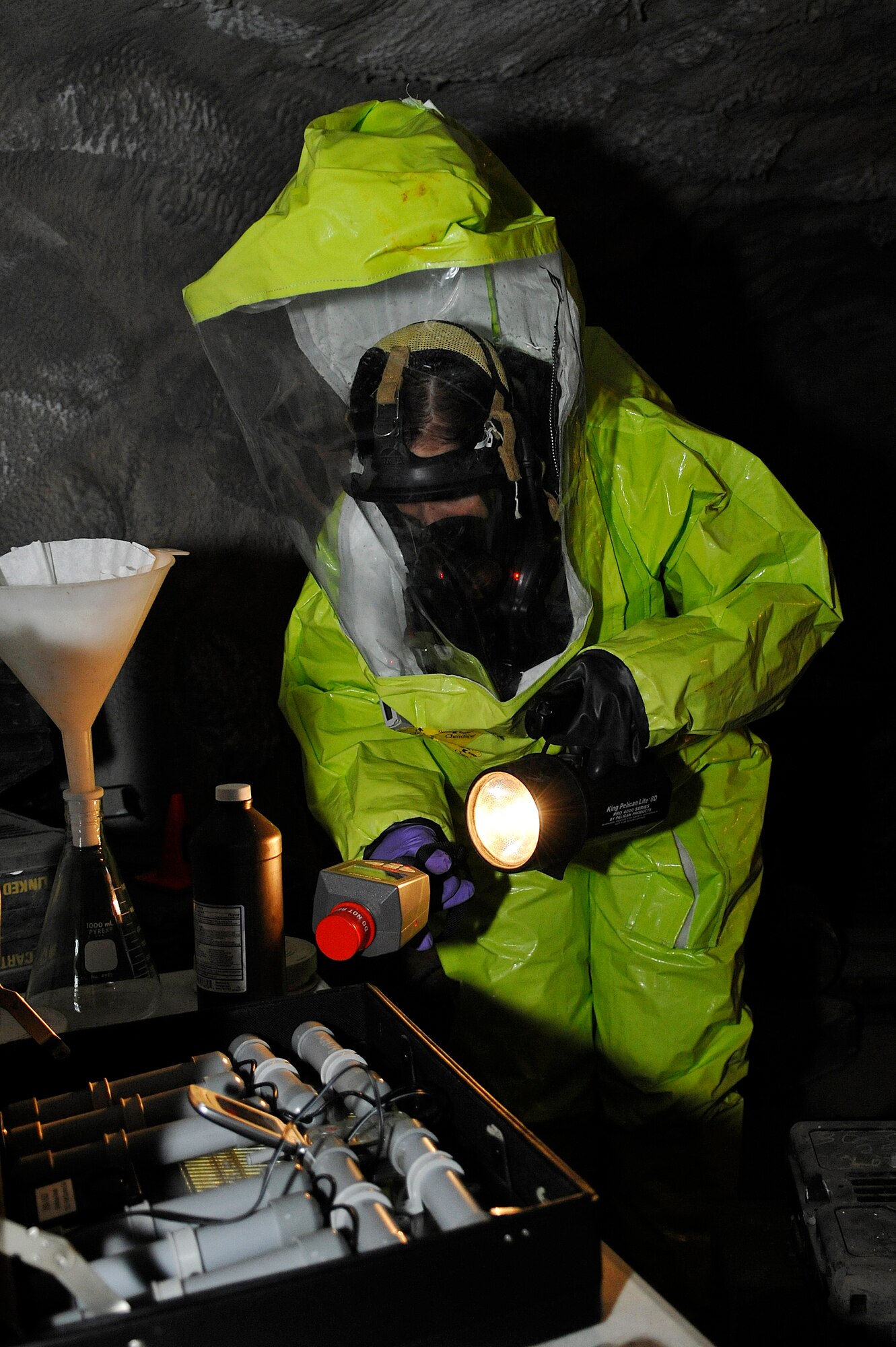 Staff Sgt. Danielle Clements, 11th Civil Engineer Squadron NCOIC of readiness and emergency management logistics, scans a table using an identiFINDER to try and indentify if there are any radioactive chemicals inside a simulated cave in Afghanistan during a Black Flag exercise in Gallagher, W. Va. March 29. Members from the 79th Medical Wing, 11 CES, and Air Force District of Washington participate in this five day exercise each year to sharpen their chemical, radiological, nuclear or high-yield explosive readiness skills. (U.S. Air Force photo/ Senior Airman Melissa V. Brownstein)