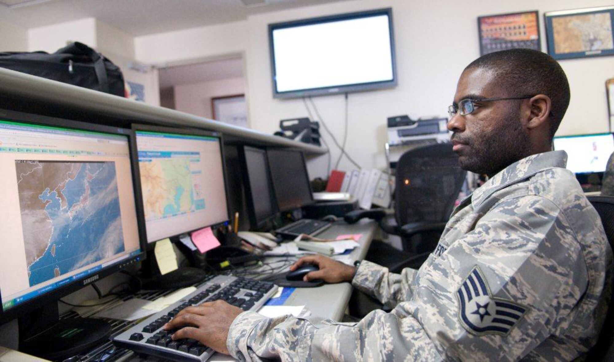 YOKOTA AIR BASE, Japan -- Staff Sgt. Robert Dandridge, 374th Operations Support Squadron weather forecaster, looks at a weather map at Yokota Air Base, Japan, April 3, 2011. Sergeant Dandridge, a native of New Baden, Ill., helps protect people and planes by forecasting weather for Yokota Air Base. "I feel my role has been vital for relief supplies to make it up north. I find it very rewarding when I see how my weather brief helps pilots make the decision on where they are going to go," said Sergeant Dandridge. (U.S. Air Force photo/Airman 1st Class Krystal M. Garrett)