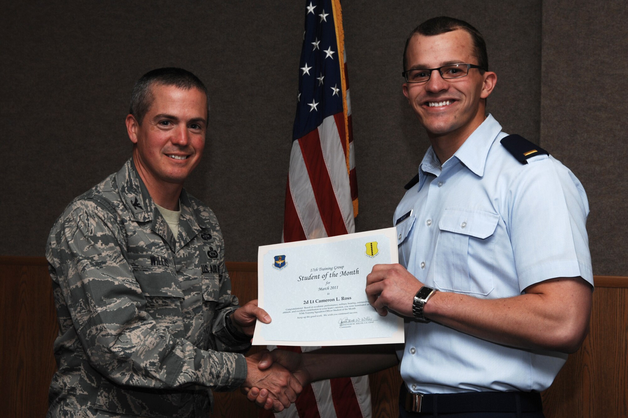 GOODFELLOW AIR FORCE BASE, Texas -- 2nd Lt. Cameron Ross, 315th Training Squadron, receives officer Student of the Month certificate from Col. J.D. Willis, 17th Training Group commander, April 1, 2011. (U.S. Air Force photo/Staff Sgt. Laura R. McFarlane)