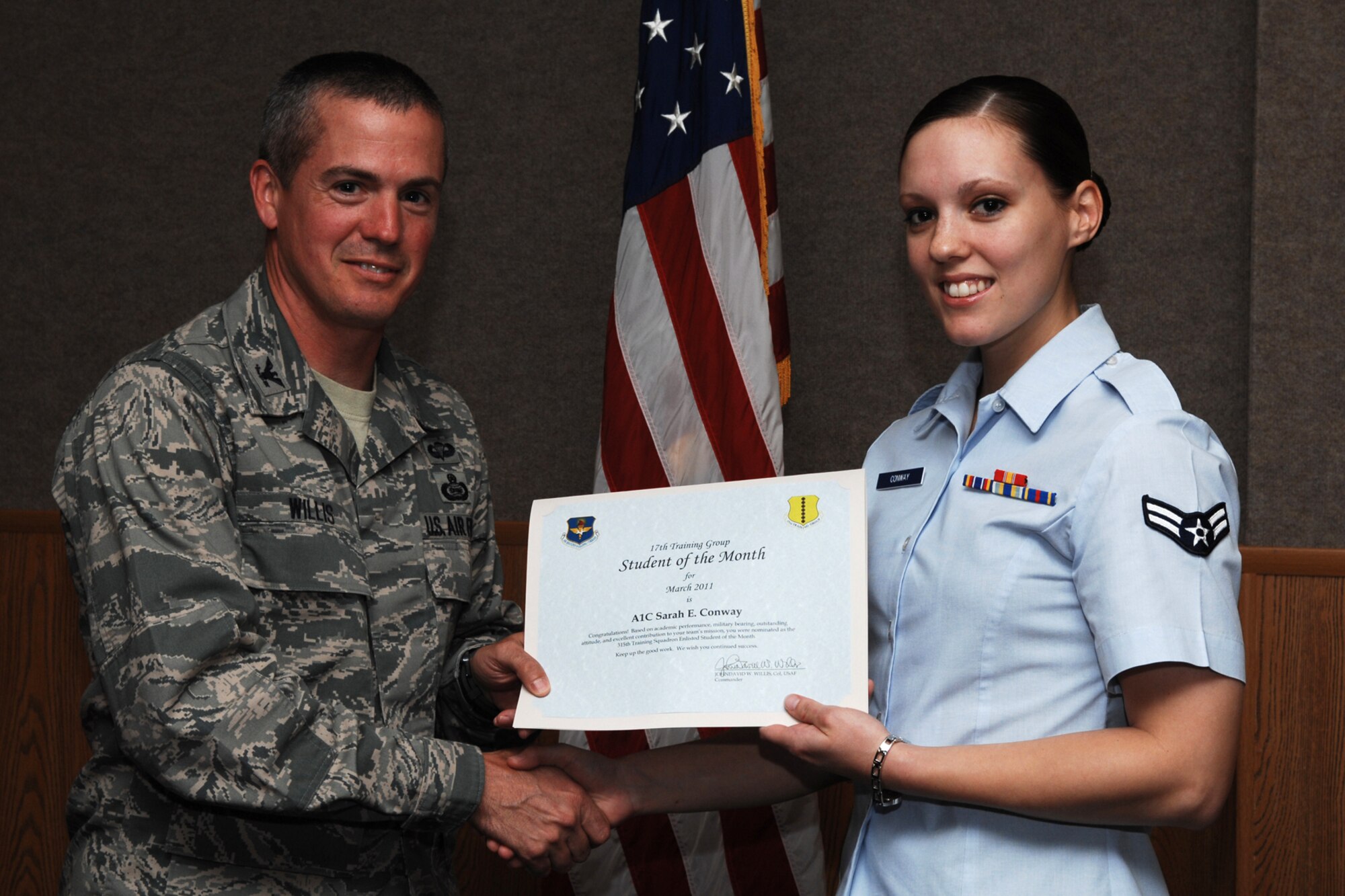 GOODFELLOW AIR FORCE BASE, Texas -- Airman 1st Class Sarah Conway, 315th Training Squadron, receives enlisted Student of the Month certificate from Col. J.D. Willis, 17th Training Group commander, April 1, 2011. (U.S. Air Force photo/Staff Sgt. Laura R. McFarlane)