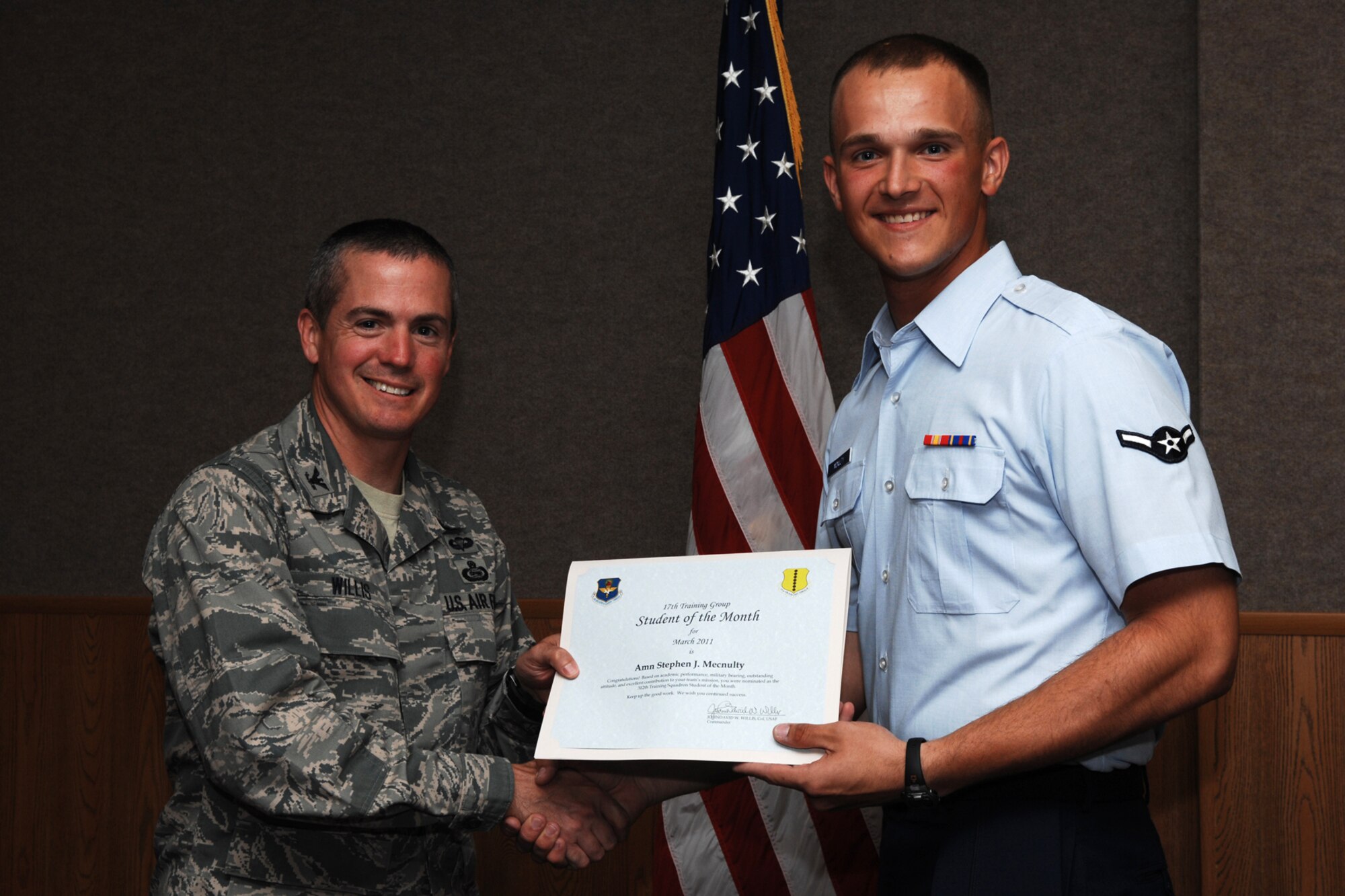 GOODFELLOW AIR FORCE BASE, Texas -- Airman Stephen McNulty, 312th Training Squadron, receives Student of the Month certificate from Col. J.D. Willis, 17th Training Group commander, April 1, 2011. (U.S. Air Force photo/Staff Sgt. Laura R. McFarlane)