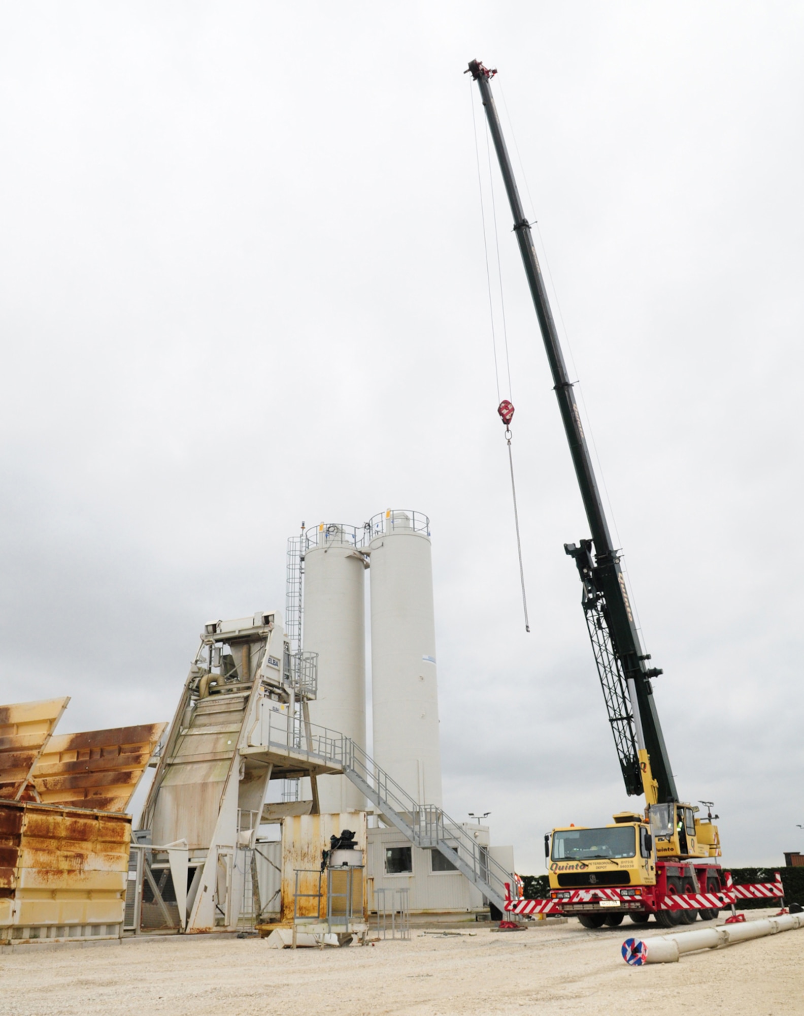 RAF MILDENHALL, England -- The new temporary concrete batching plant stands here March 30, 2011. This plant will enable contractors to mix concrete on site, rather than having to transport truckloads of ready-mixed concrete from miles away, saving time and money. Concrete made here will be used for airfield repairs being carried out during the next six months, replacing hardstands and repairing the taxiway. (U.S. Air Force photo/Karen Abeyasekere)