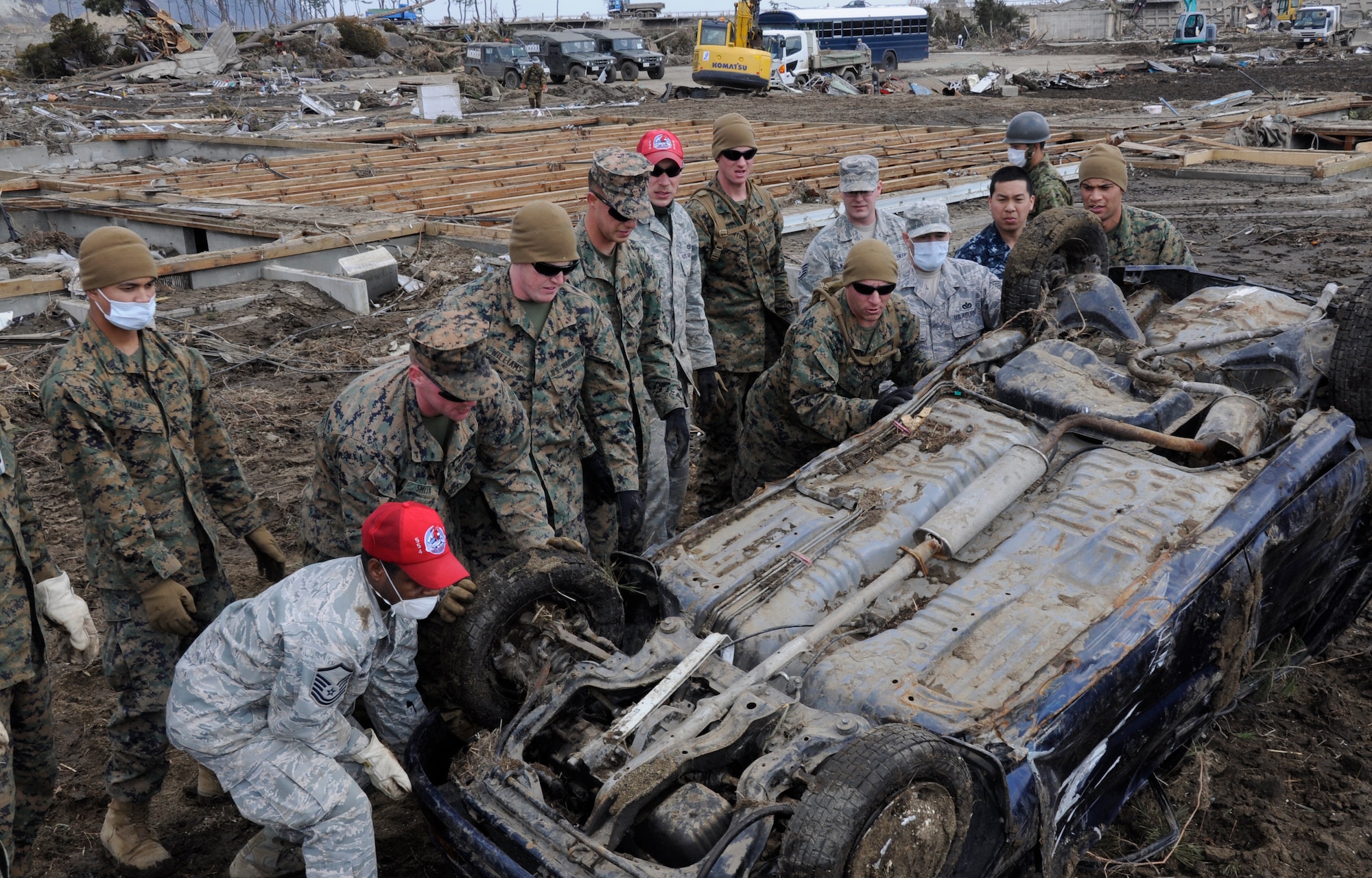NODA MURA, Iwate, Japan – U.S. service members prepare to lift a car in a tsunami-struck area here March 29. Nearly 40 U.S. service members and civilians left Misawa Air Base, Japan, to assist in tsunami cleanup and relief efforts in the village as part of Operation Tomodachi. (U.S. Air Force photo by Senior Airman Joe McFadden/Released)