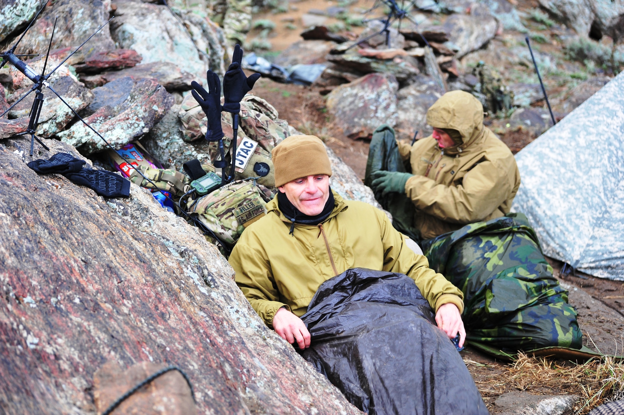 Lt. Col. Brian Filler (Left), air liaison officer, and Tech. Sgt. Jonathan Oliver, a joint terminal attack controller, prepare to sleep in austere conditions upon a remote mountaintop during Operation Bull Whip in Laghman province, Afghanistan, March 28, 2011.  The Airmen are assigned to Bagram Airfield’s 817th Expeditionary Air Support Operations Squadron, and were responsible for controlling air assets during the clearing operation. (U.S. Air Force photo by Capt. Erick Saks) 