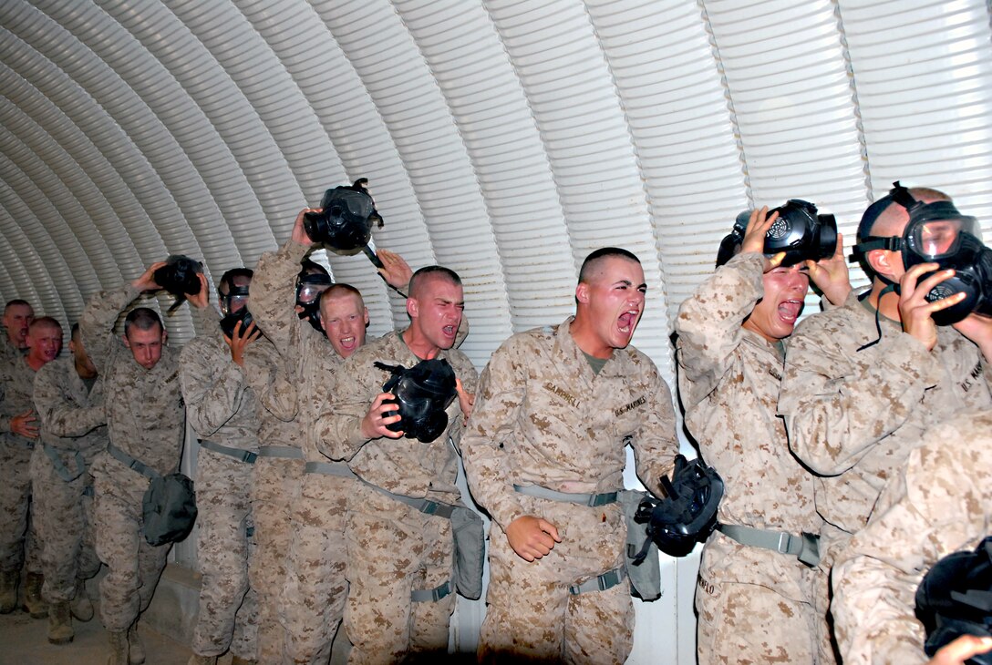 Recruits from Company G evacuate the confidence chamber after they finish applying their new skill of clearing a gas mask April 4.