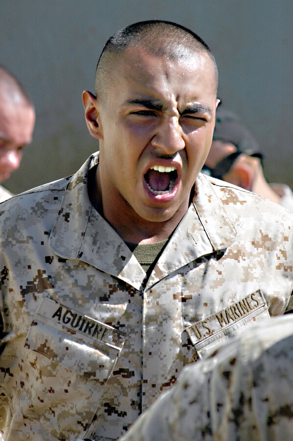 Recruit Nicholas A. Aguirre, Company G, yells out a war cry as he runs out of the confidence chamber April 4. Aguirre and the other recruits were subjected to the effects of CS gas to familiarize them with their gear and the symptoms they may encounter in combat.