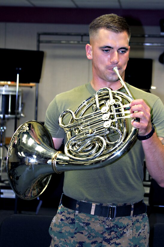 Sgt. Ryan Jones, a native of Penfield, N.Y., practices playing his French horn in one of the rehearsal rooms at the band hall aboard Marine Corps Recruit Depot San Diego. Jones has been playing the French horn for 12 years, but is turning in his horn to re-enlist and change his current military occupational specialty to Reconnaissance.