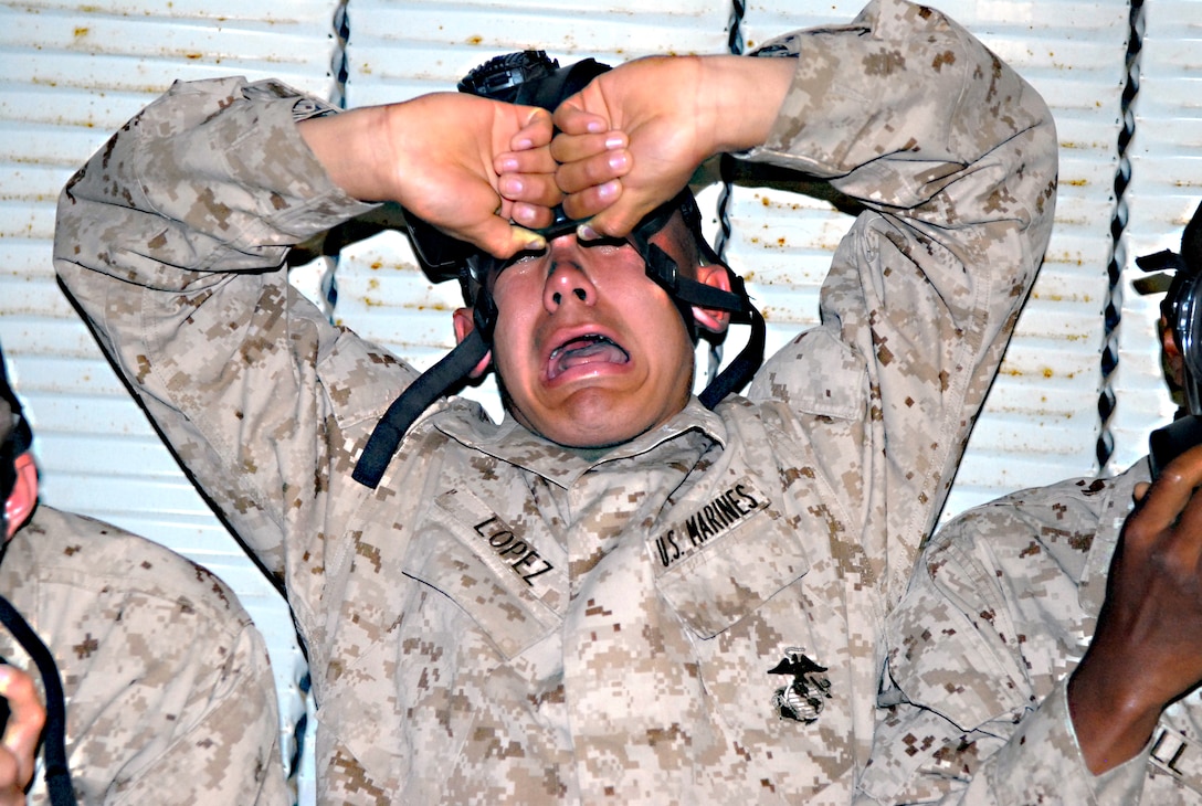 A recruit from Company G reacts to the 2-chlorobenzalmalononitrile also known as CS gas, a defining component of tear gas, after breaking the seal of his mask in the confidence chamber April 4. The confidence chamber simulates the type of environment a Marine may encounter in a chemical, biological, radiological and nuclear warfare situation. A recruit from Company G reacts to the 2-chlorobenzalmalononitrile also known as CS gas, a defining component of tear gas, after breaking the seal of the mask.