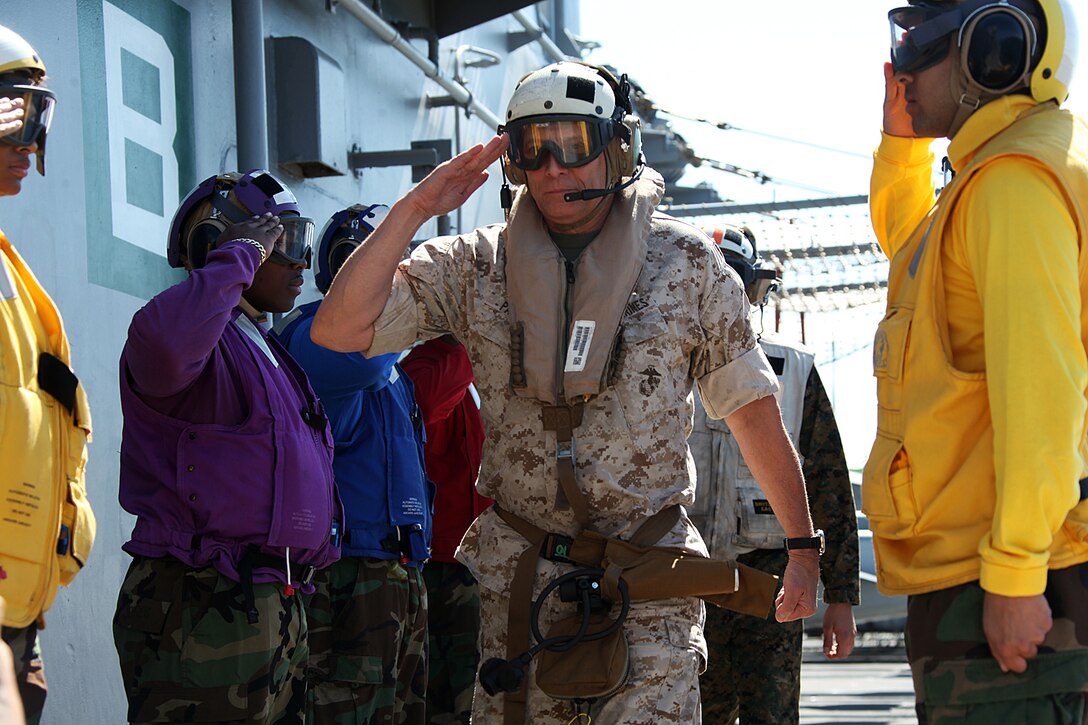Lieutenant General John M. Paxton, commanding general, II Marine Expeditionary Force, center, salutes U.S. Navy ceremonial sideboys while boarding USS Bataan during a visit to the ship, April 4, 2011.  The Marines and sailors of the 22nd MEU are currently deployed with Amphibious Squadron 6 aboard the USS Bataan Amphibious Ready Group and will continue to train and test the MEU’s ability to operate as a cohesive and effective Marine Air Ground Task Force.  The 22nd MEU is a multi-mission capable Marine Air Ground Task Force comprised of Aviation Combat Element, Marine Medium Tilt Rotor Squadron 263 (Reinforced); Logistics Combat Element, Combat Logistics Battalion 22; Ground Combat Element, Battalion Landing Team, 2nd Battalion, 2nd Marine Regiment; and its command element.