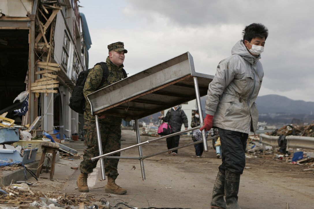 An Oshima island resident and a Marine with the 31st Marine Expeditionary Unit move a table during Operation “Field Day,” April 3. The MEU currently has approximately 300 Marines and sailors helping with clean-up efforts in the devastated area. The 31st MEU is ready to support its Japanese partners and to provide assistance when called upon.