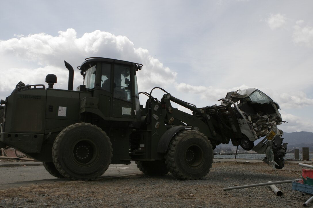 A forklift with the 31st Marine Expeditionary Unit removes a wrecked car during Operation “Field Day,” April 3. The MEU currently has approximately 300 Marines and sailors helping with clean-up efforts in the devastated area. The 31st MEU is ready to support its Japanese partners and to provide assistance when called upon.