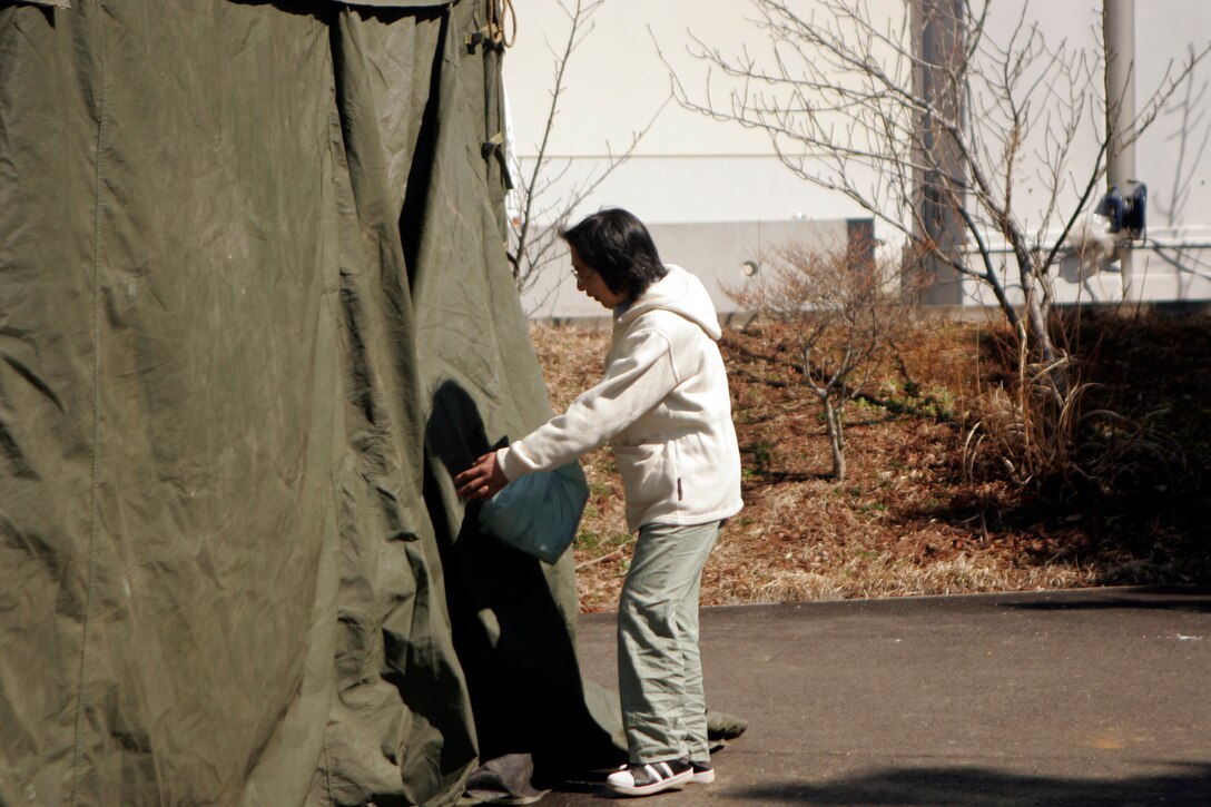 A woman uses showers set up by Marines with the 31st Marine Expeditionary Unit, April 5. As part of Operation Tomodachi, the 31st MEU is ready to support our Japanese partners and to provide assistance when called upon.