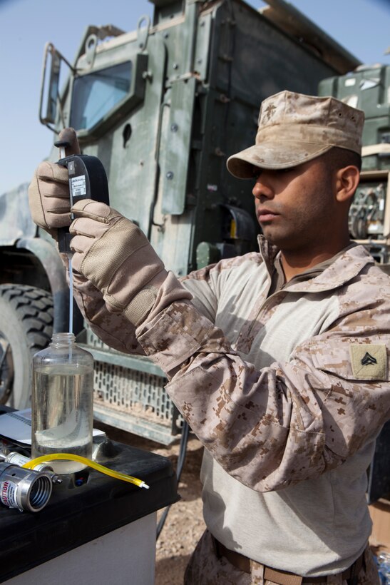 Cpl. David Reinoso, a bulk fuel specialist with Marine Wing Support Squadron 272, examines fuel for sediments ensuring it is suitable for use at a new forward arming and refueling point at Combat Outpost Ouellette in Afghanistan's Helmand province, April 5.The forward arming and refueling point was recently constructed at Combat Outpost Ouellette to enable 2nd Marine Aircraft Wing (Forward) to better support Marines and other coalition troops operating near Sangin, Afghanistan.